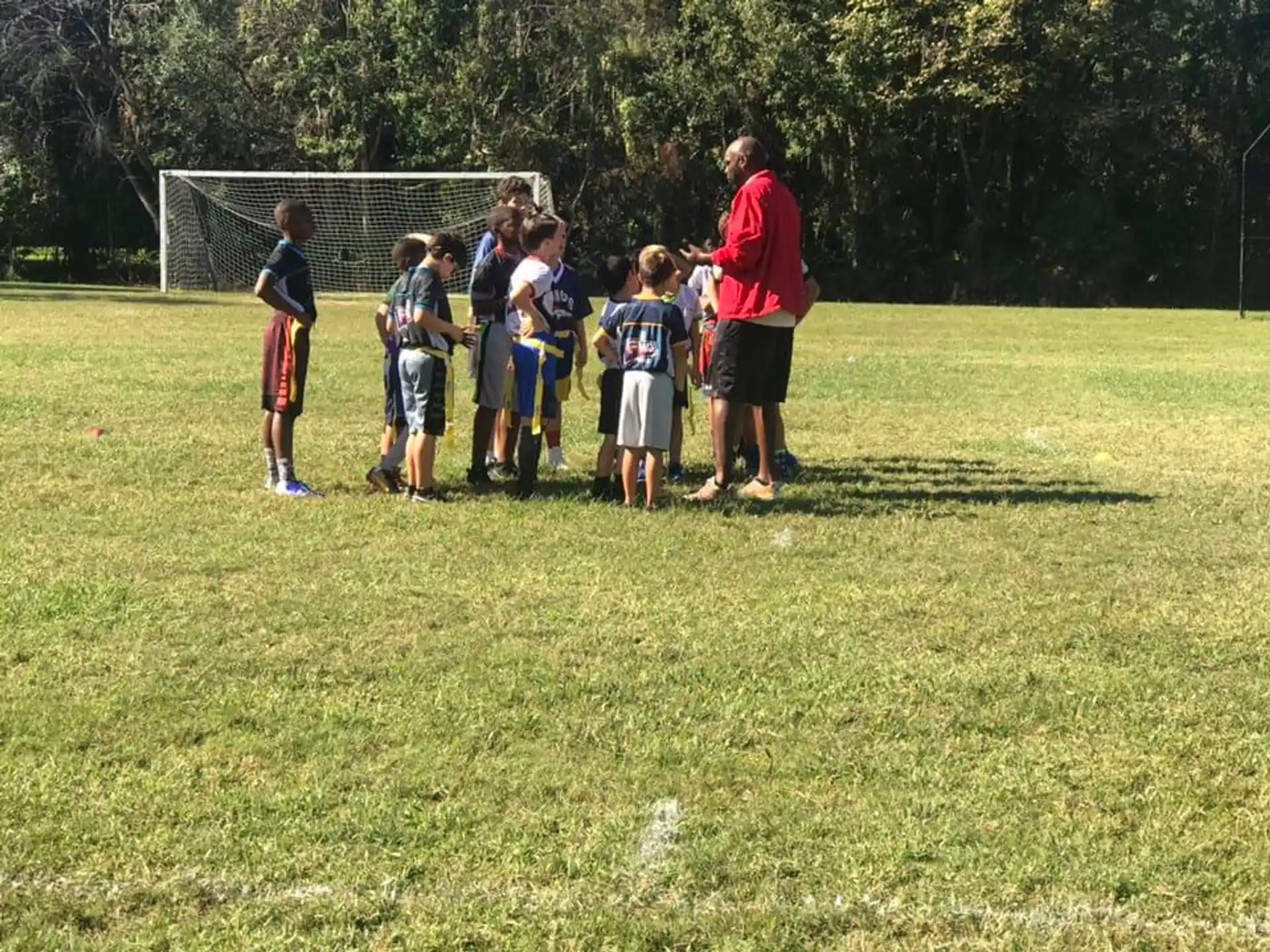 a group of kids standing on a field