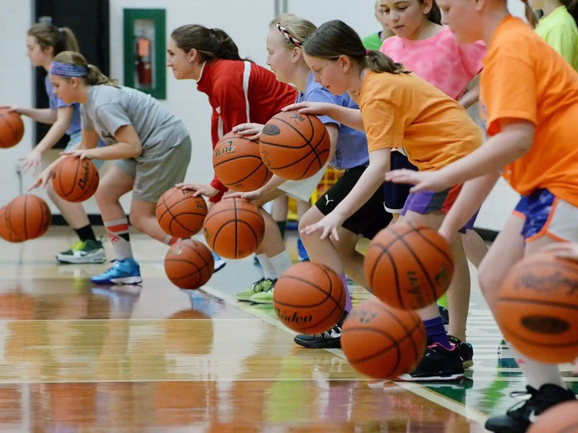 a group of girls playing basketball