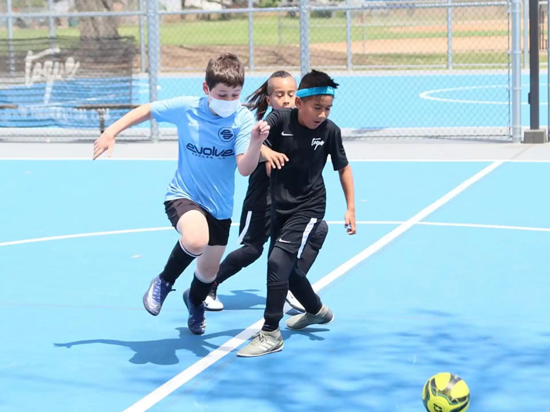 a group of kids playing football