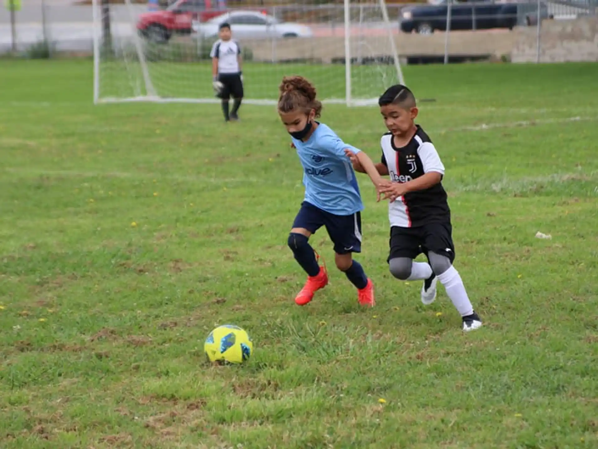 kids chasing a football ball