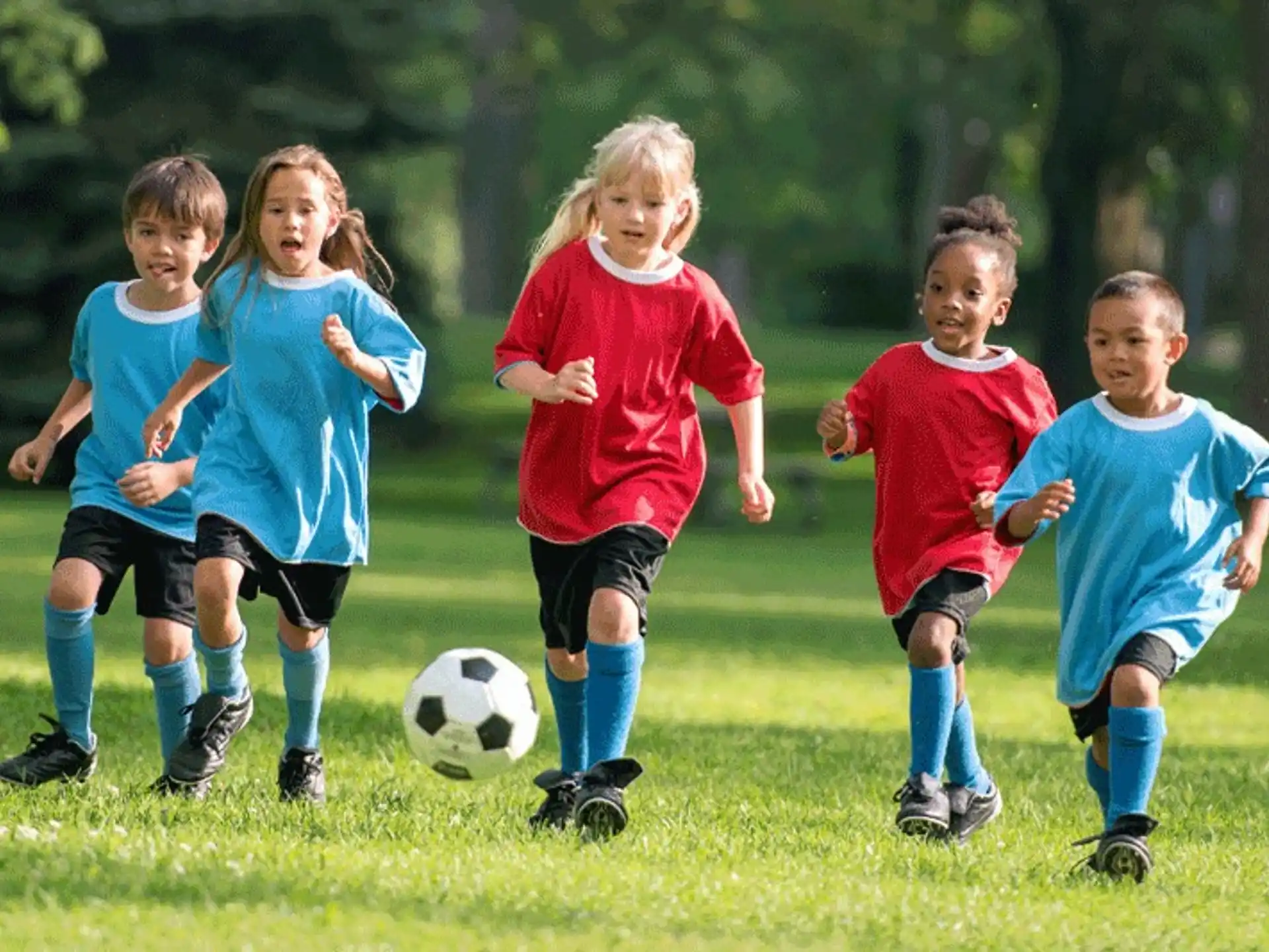 a group of kids playing football