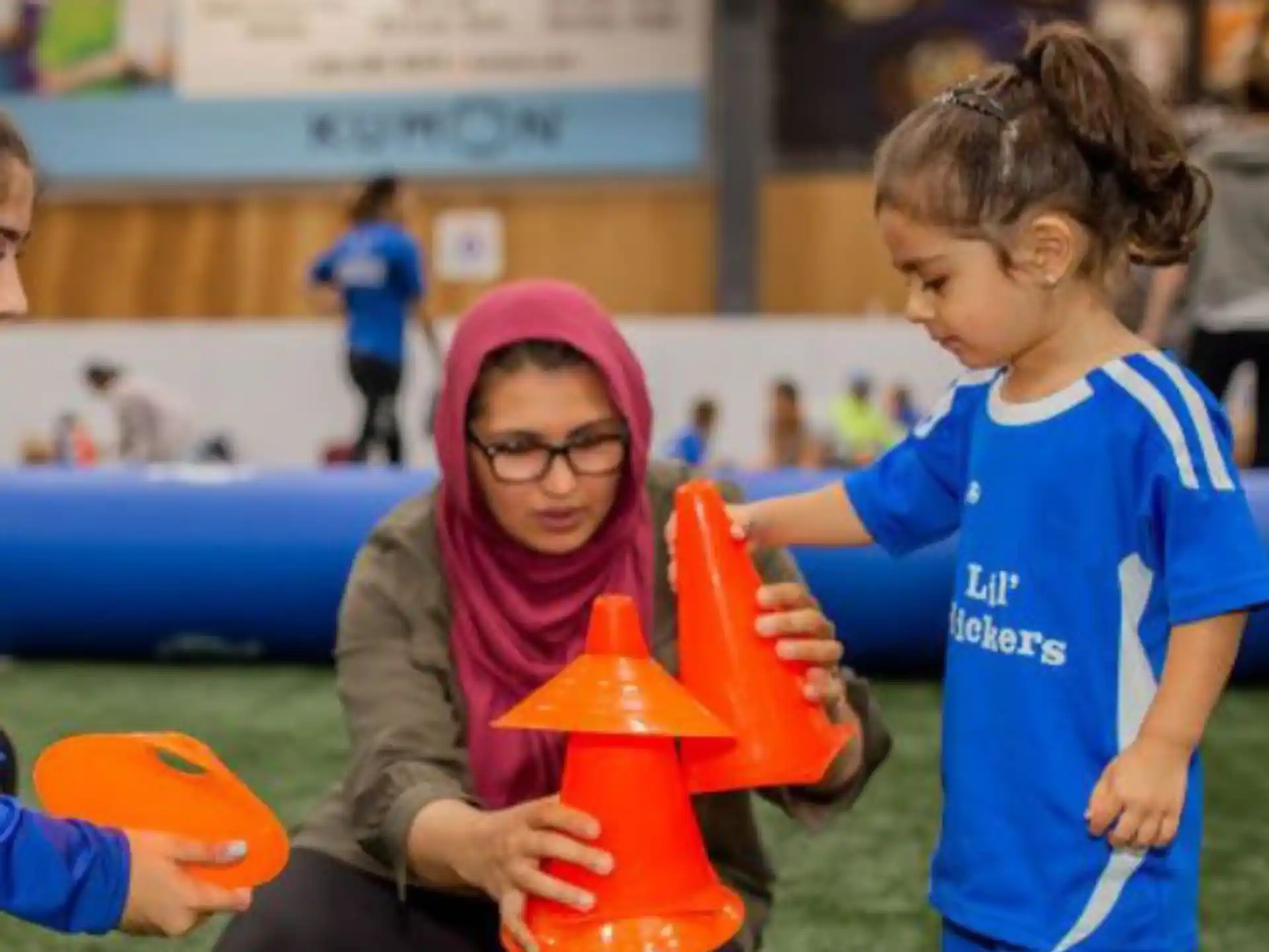 a person helping a child with a toy