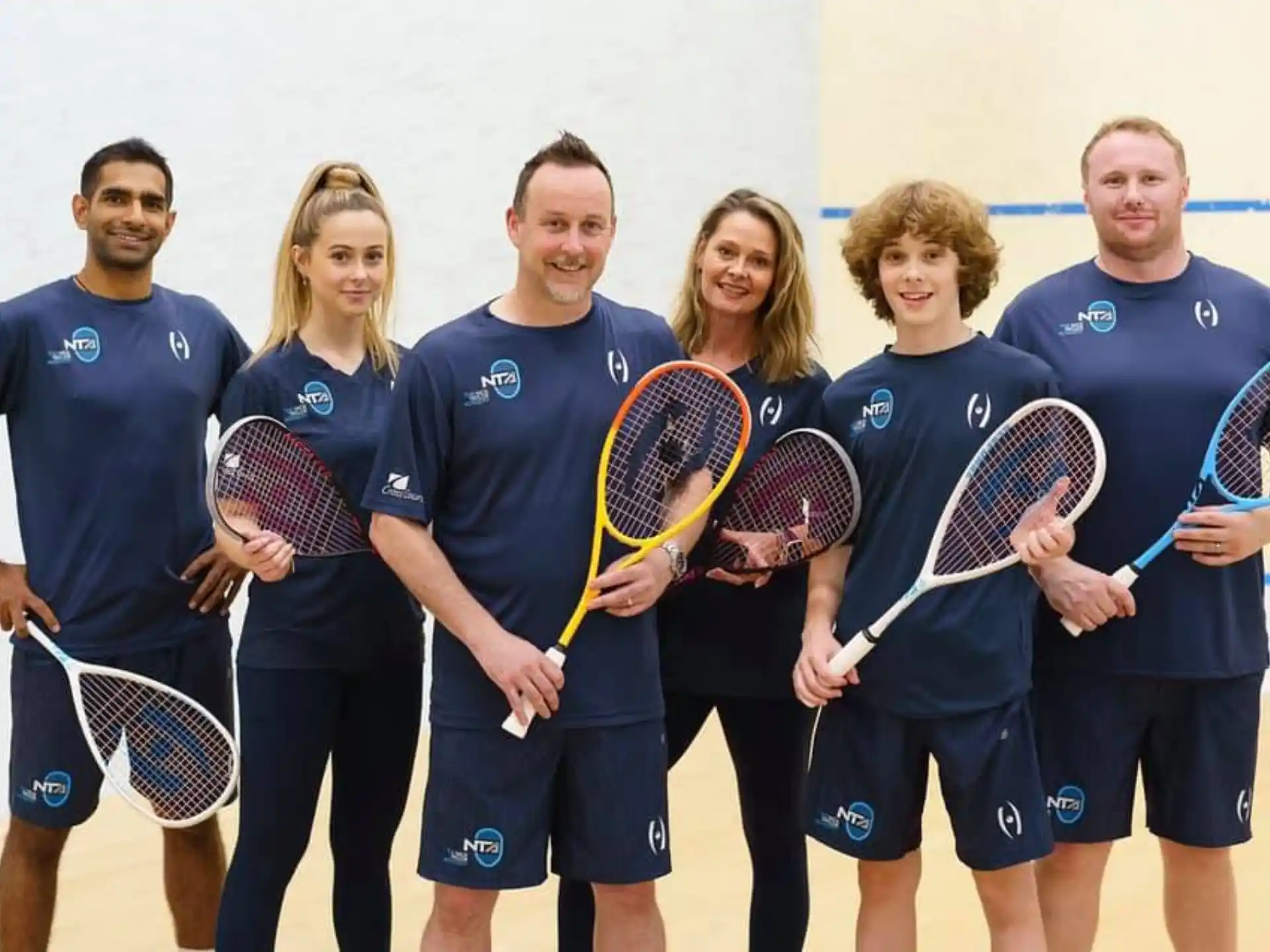 a group of people holding tennis rackets