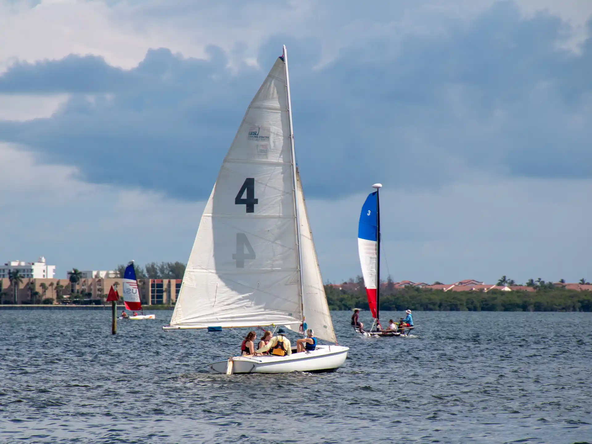 a group of people on a sailboat on the water