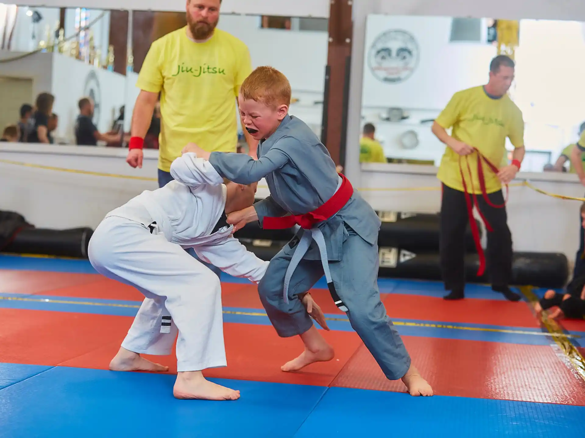 a boy and a man in a karate uniform