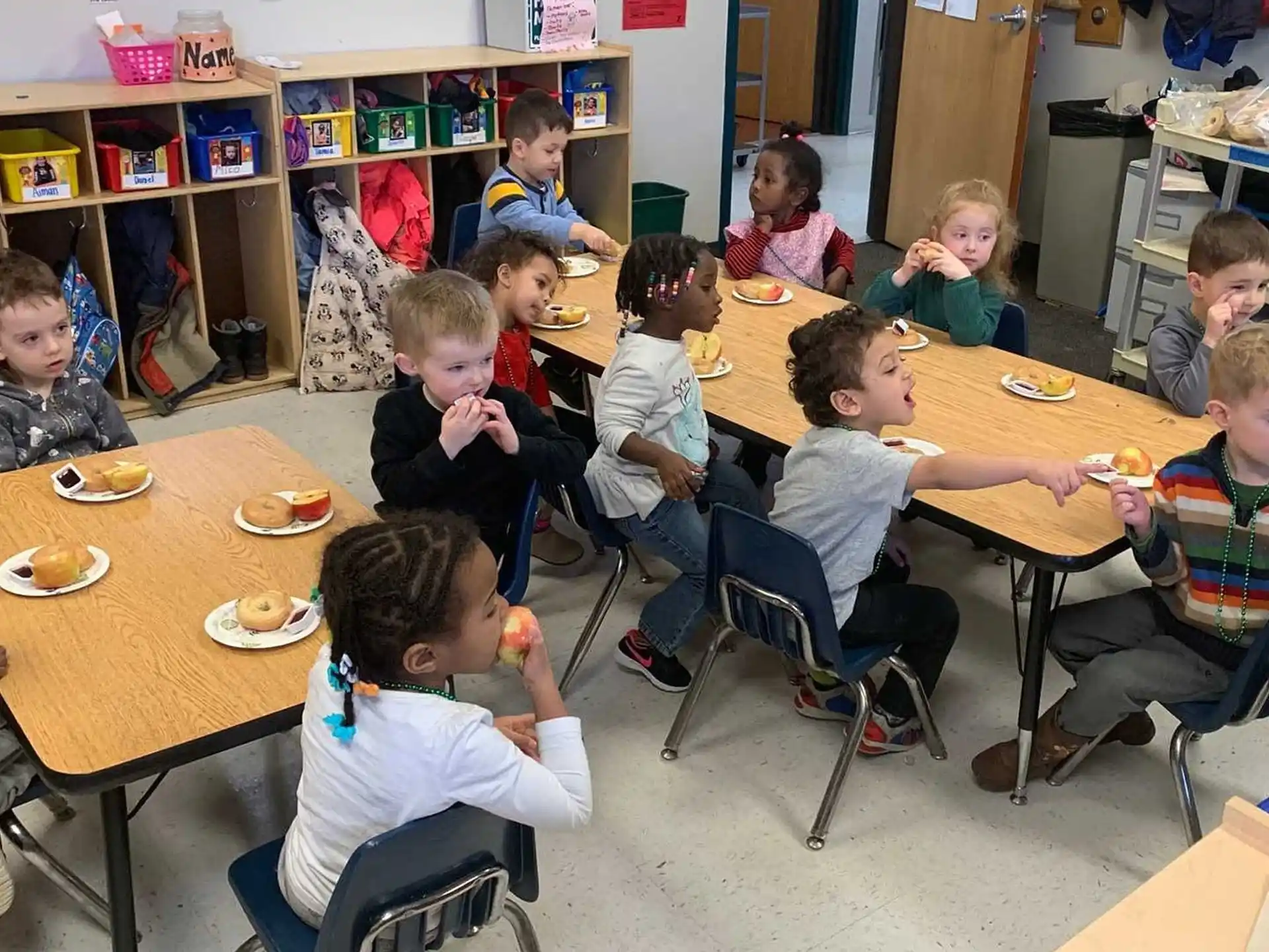 a group of children eating at a table