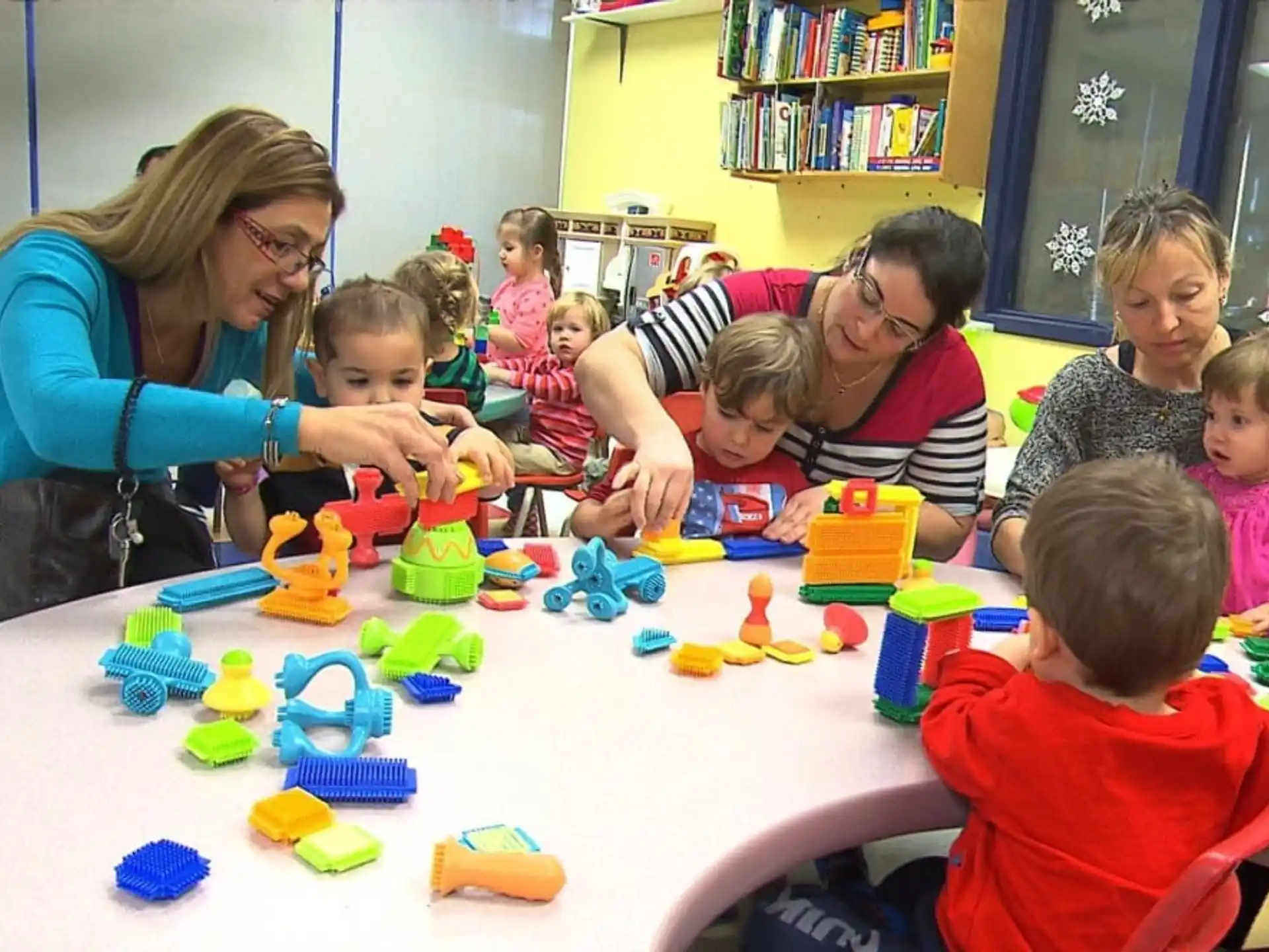 a group of people playing with toys