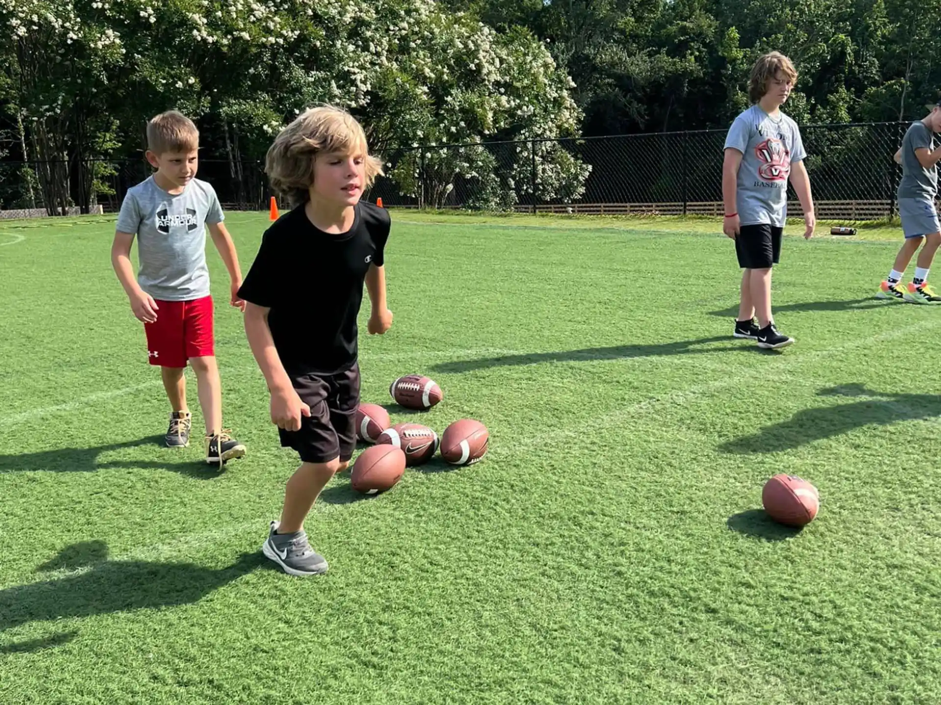 a group of kids playing with balls