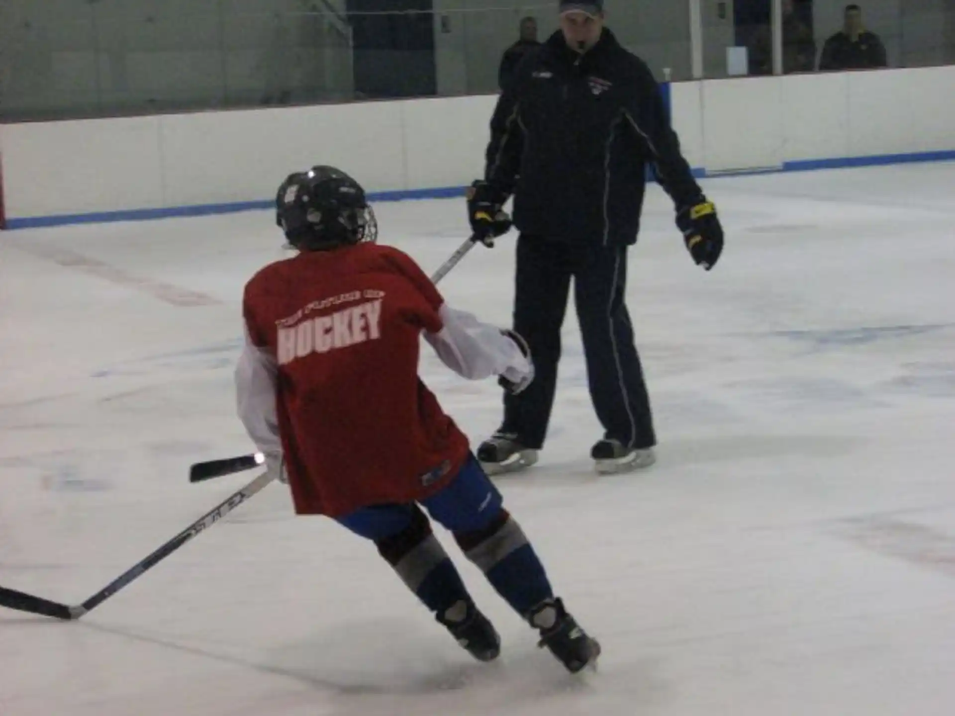 a man and a woman playing hockey