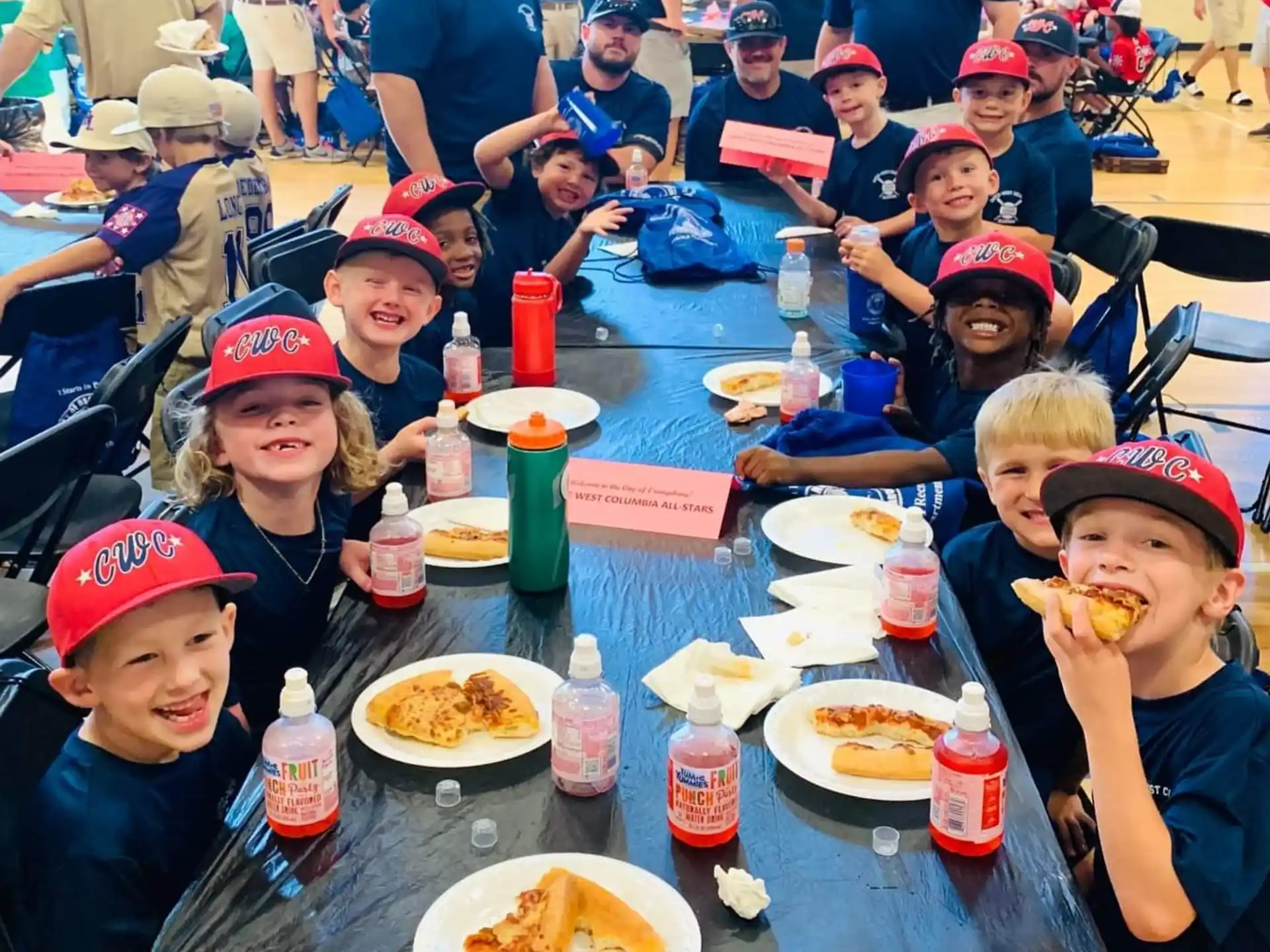 a group of kids eating at a table