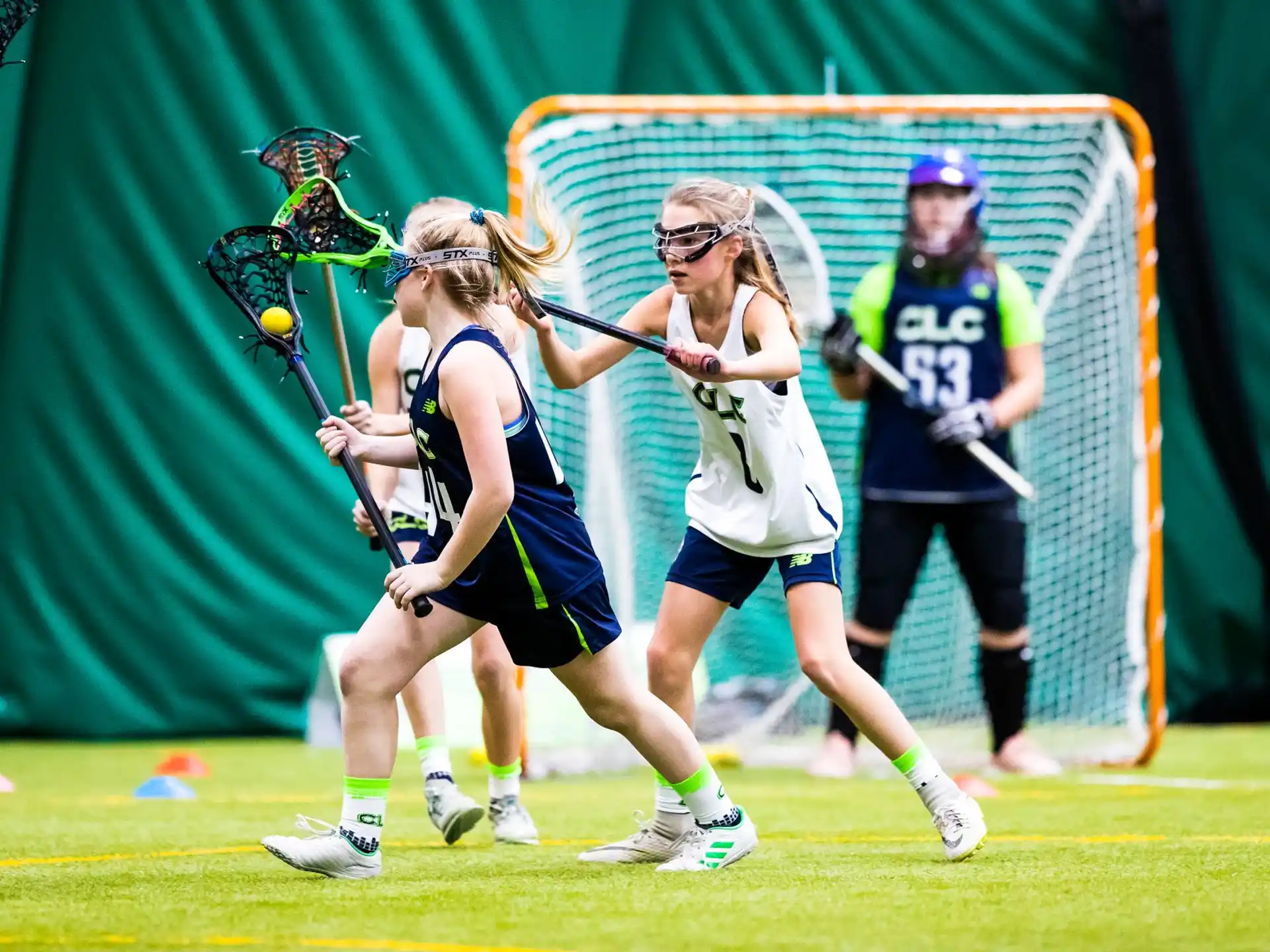 women playing lacrosse on a field