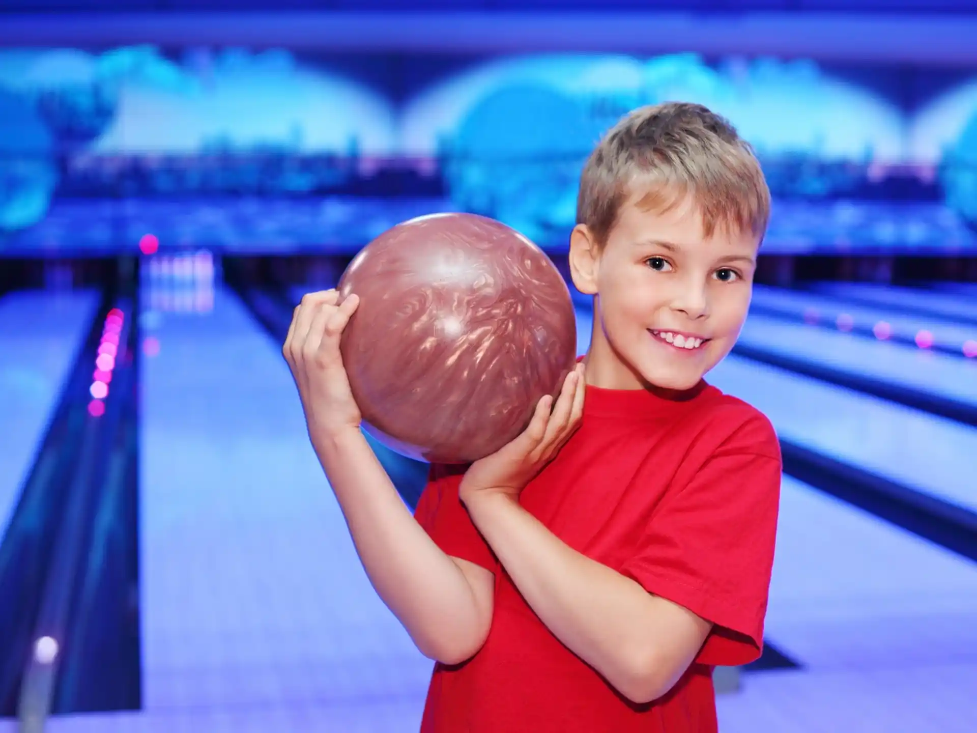 a boy holding a ball