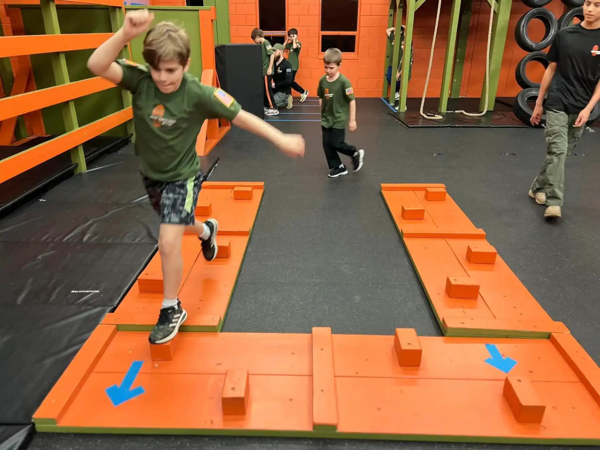 a boy jumping on a playground