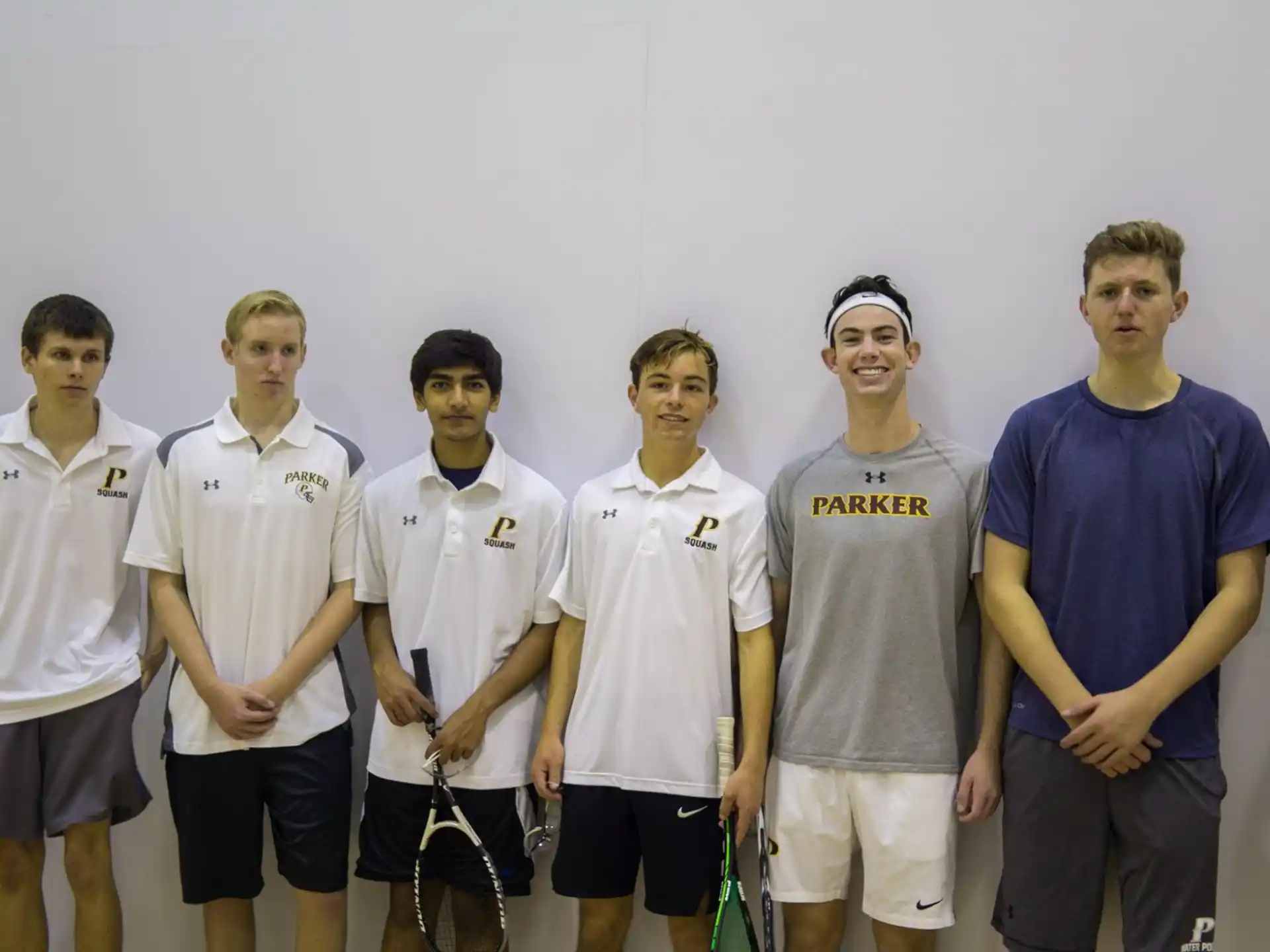a group of men wearing white shirts