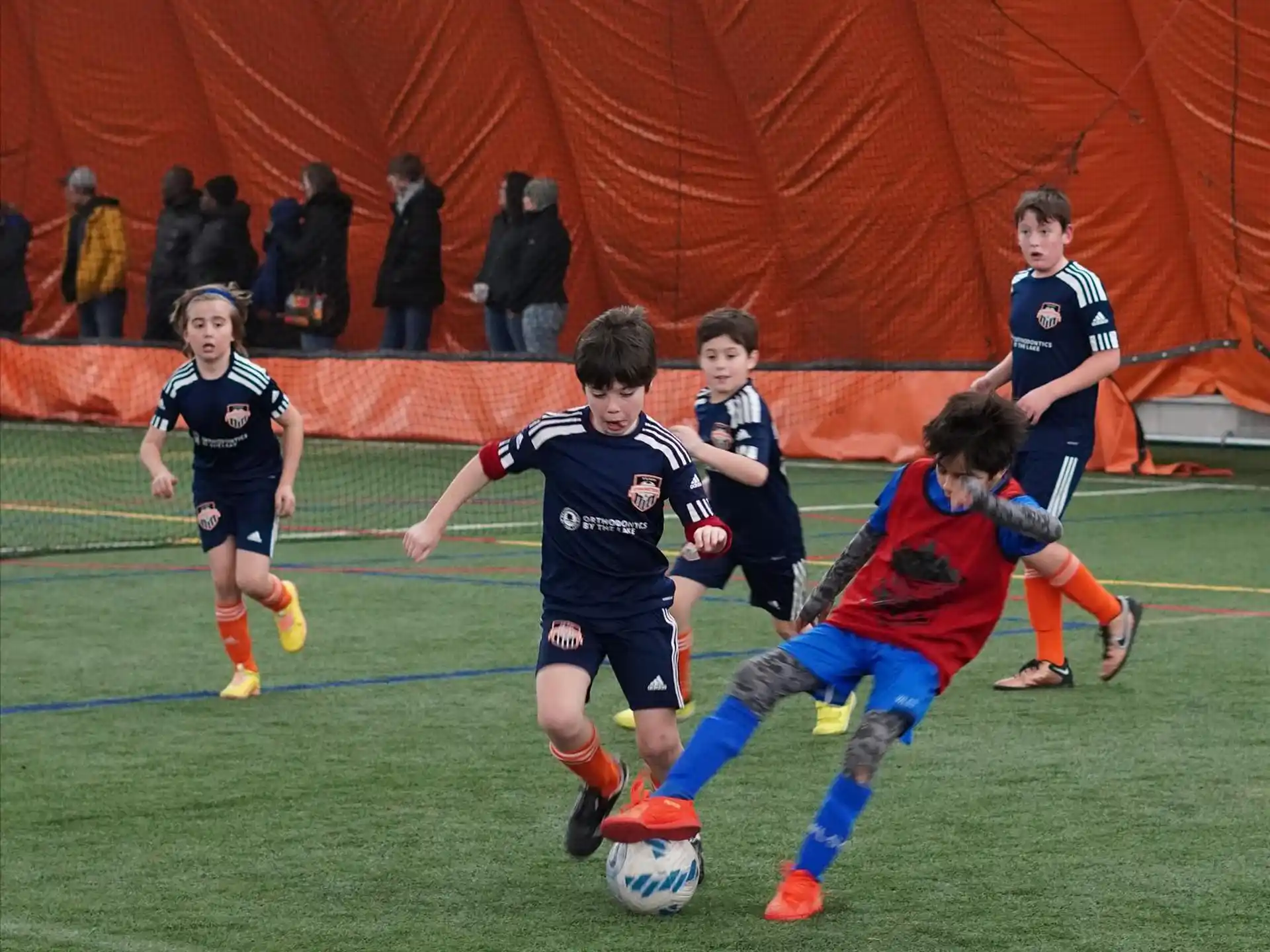 a group of kids playing football