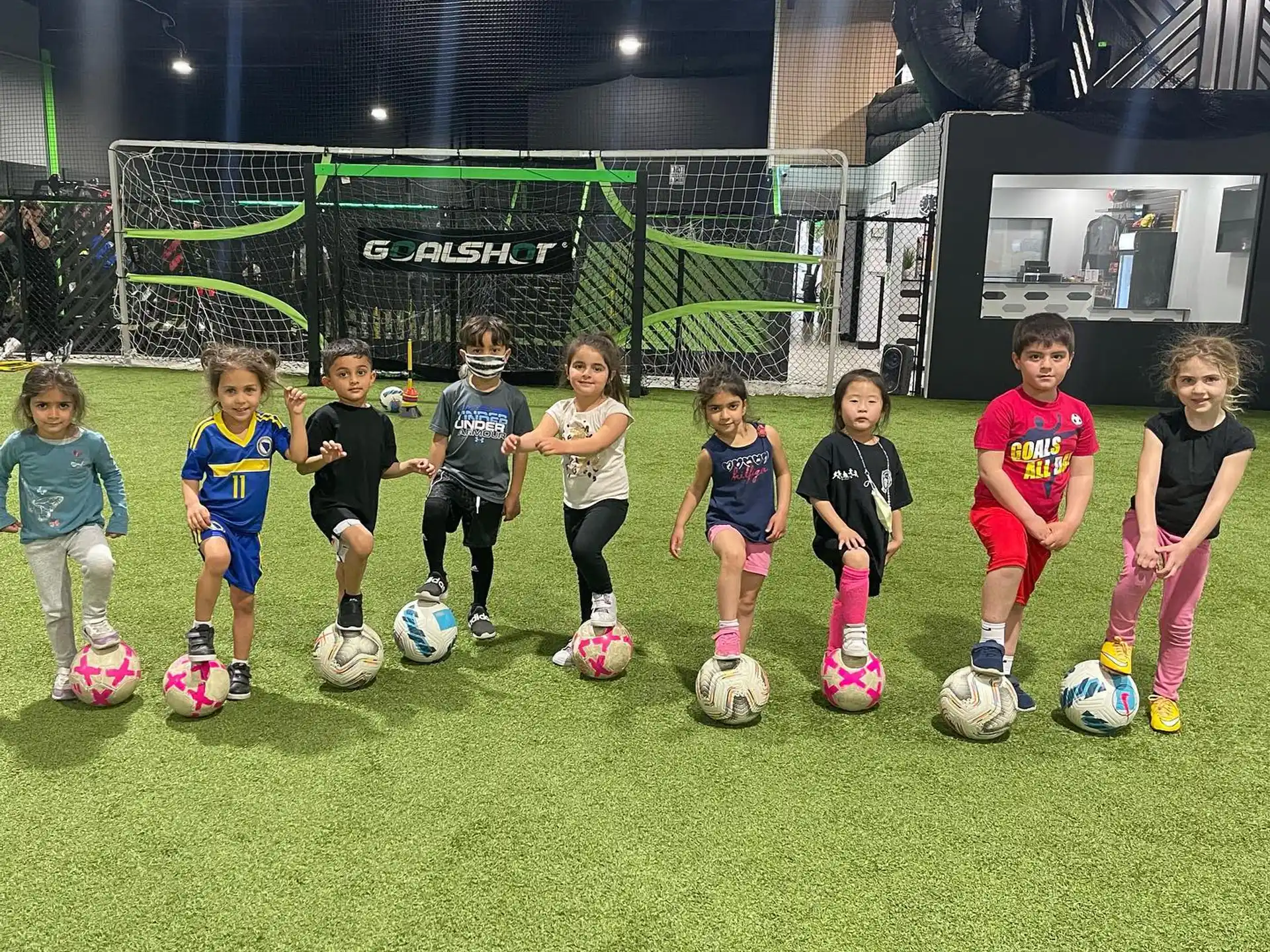 a group of kids with football balls