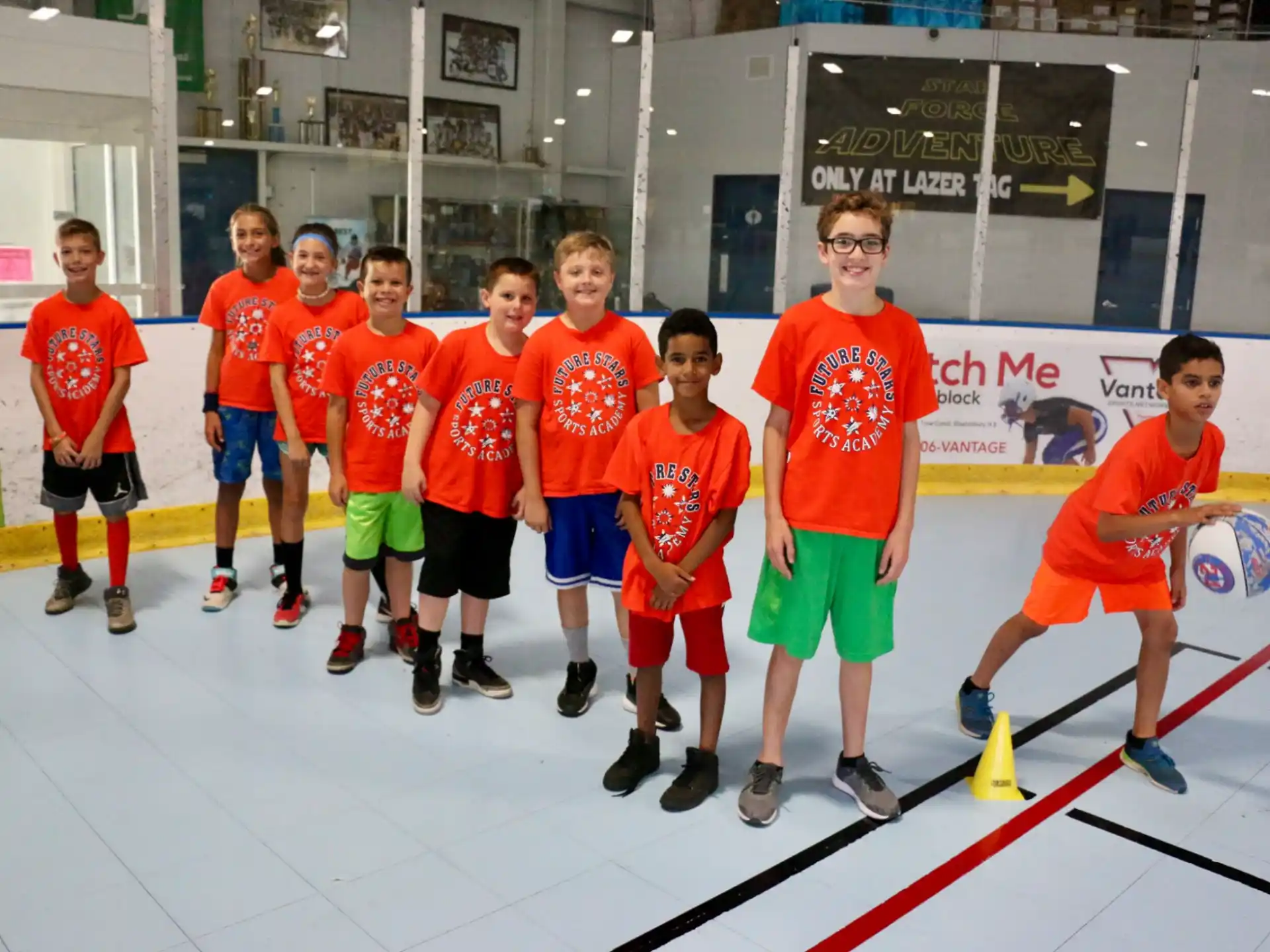a group of boys in orange shirts