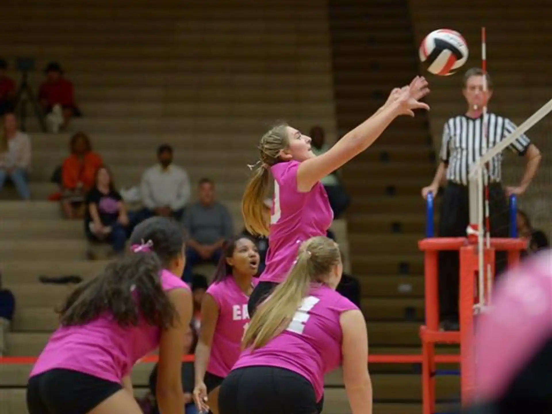 a group of people playing volleyball