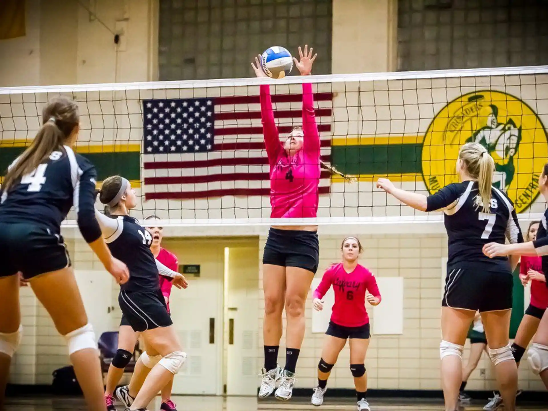 a group of women playing volleyball