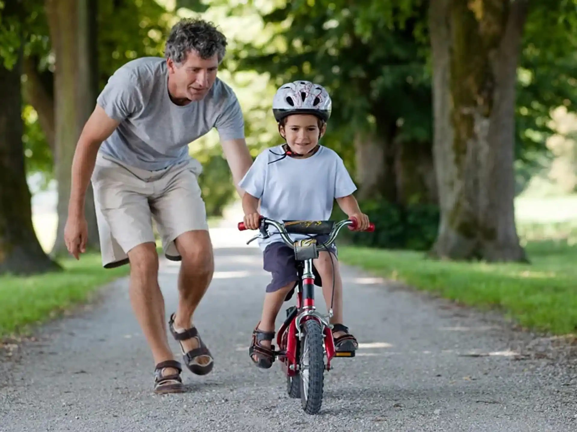 a man and a boy riding a bicycle