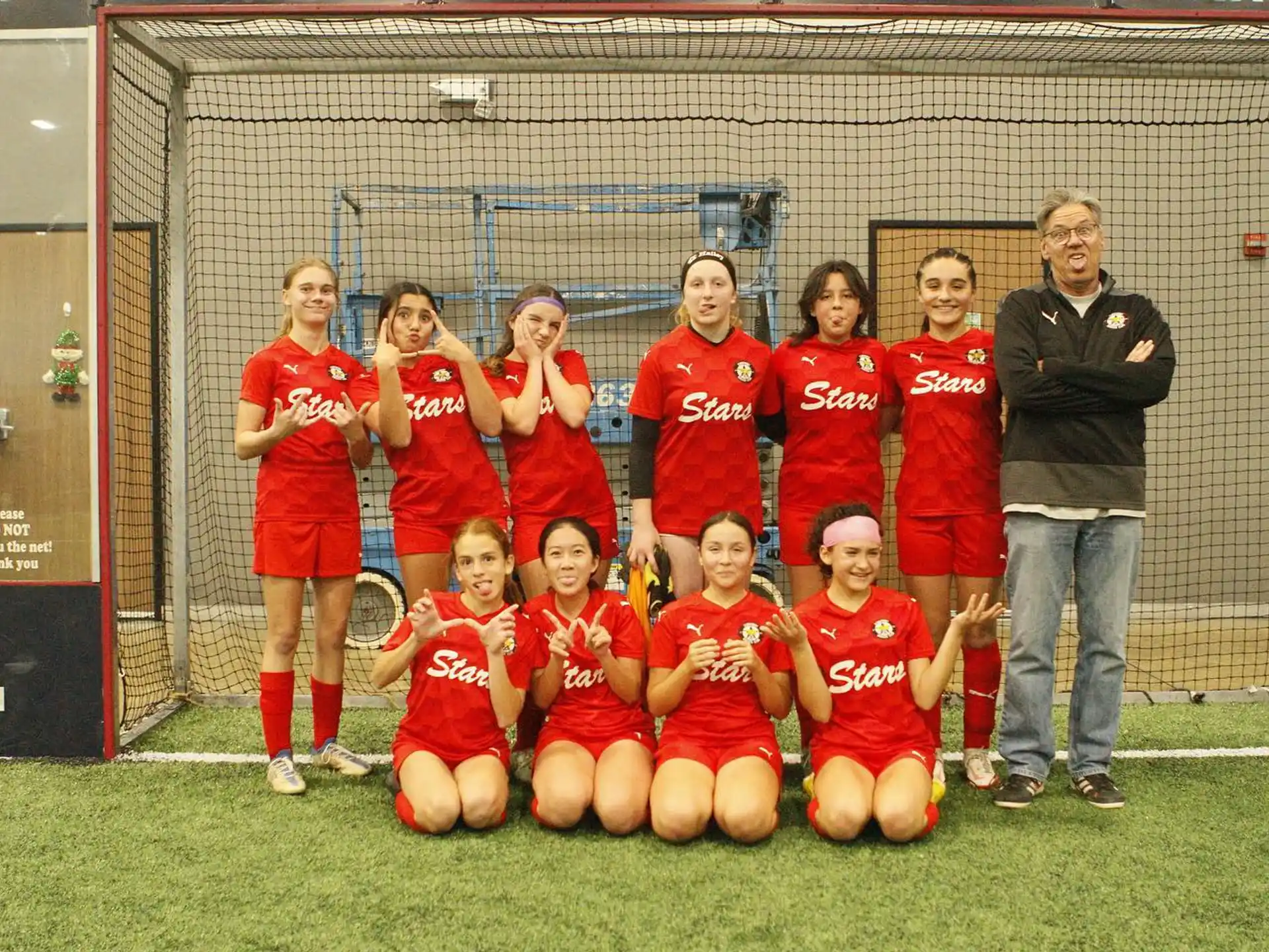a group of people in sports uniforms posing for a photo