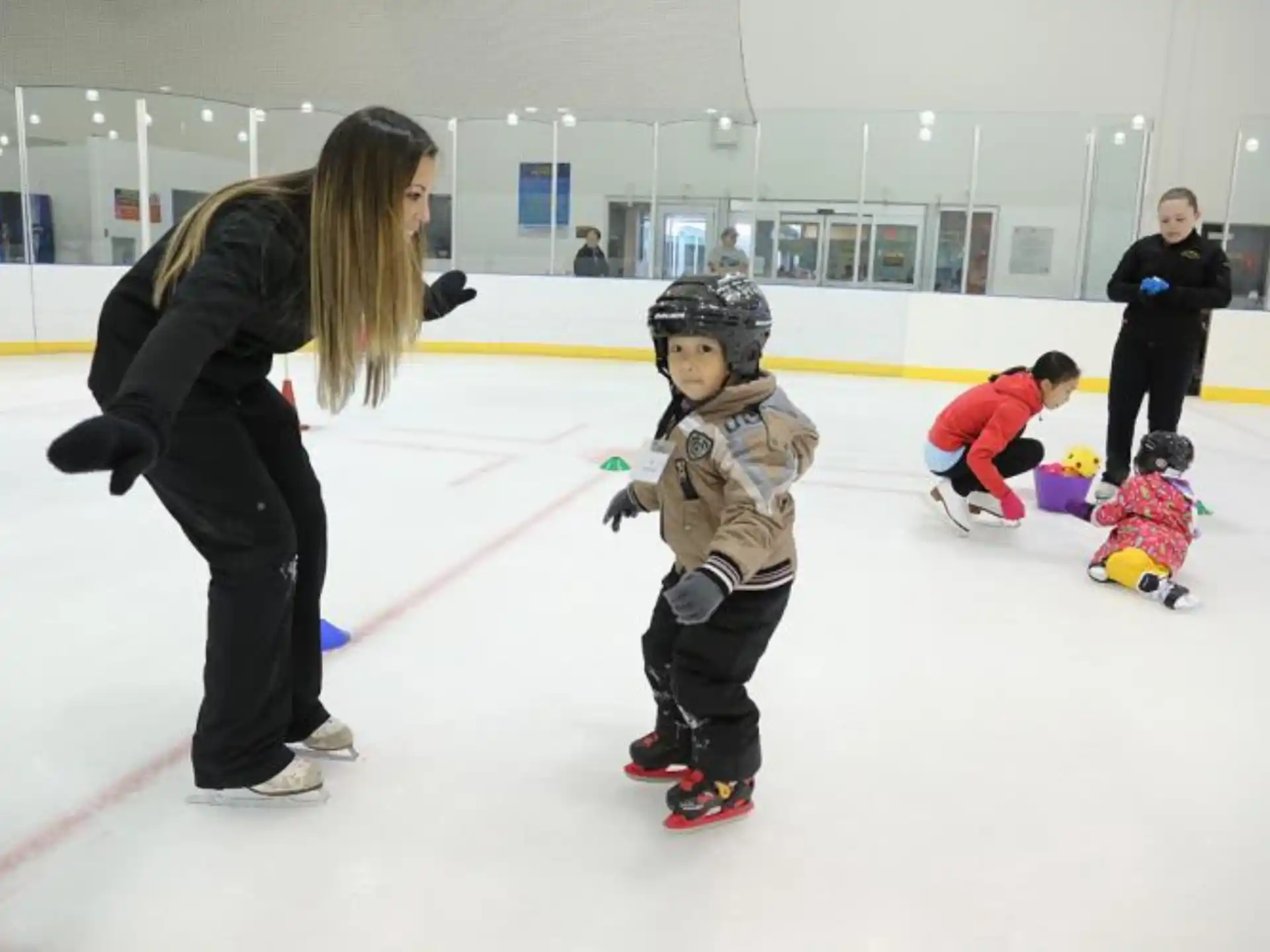 a person and a child on an ice rink