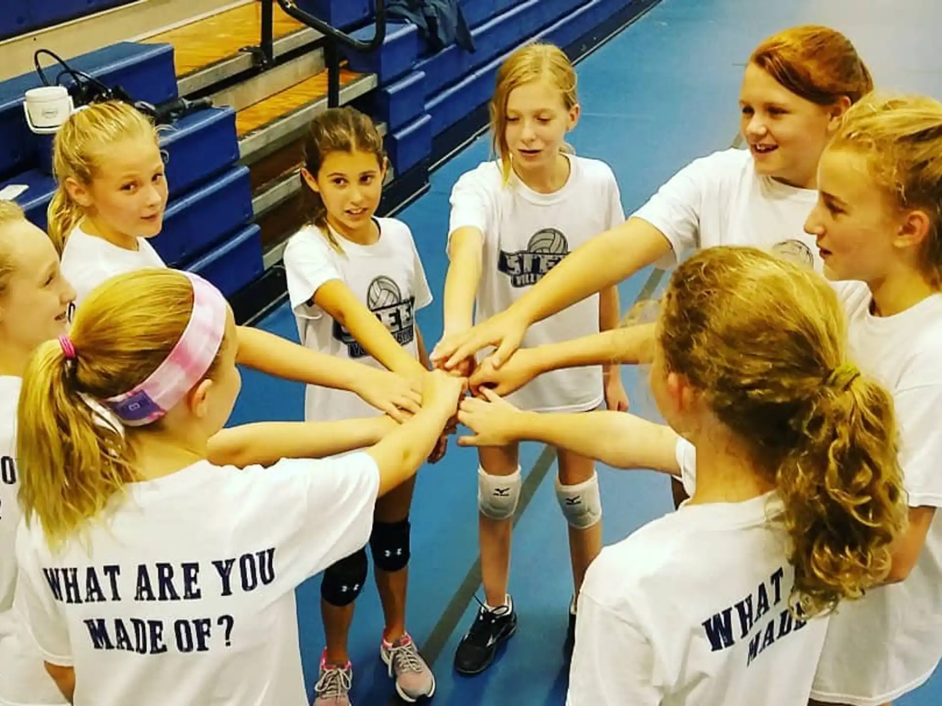 a group of girls in white shirts