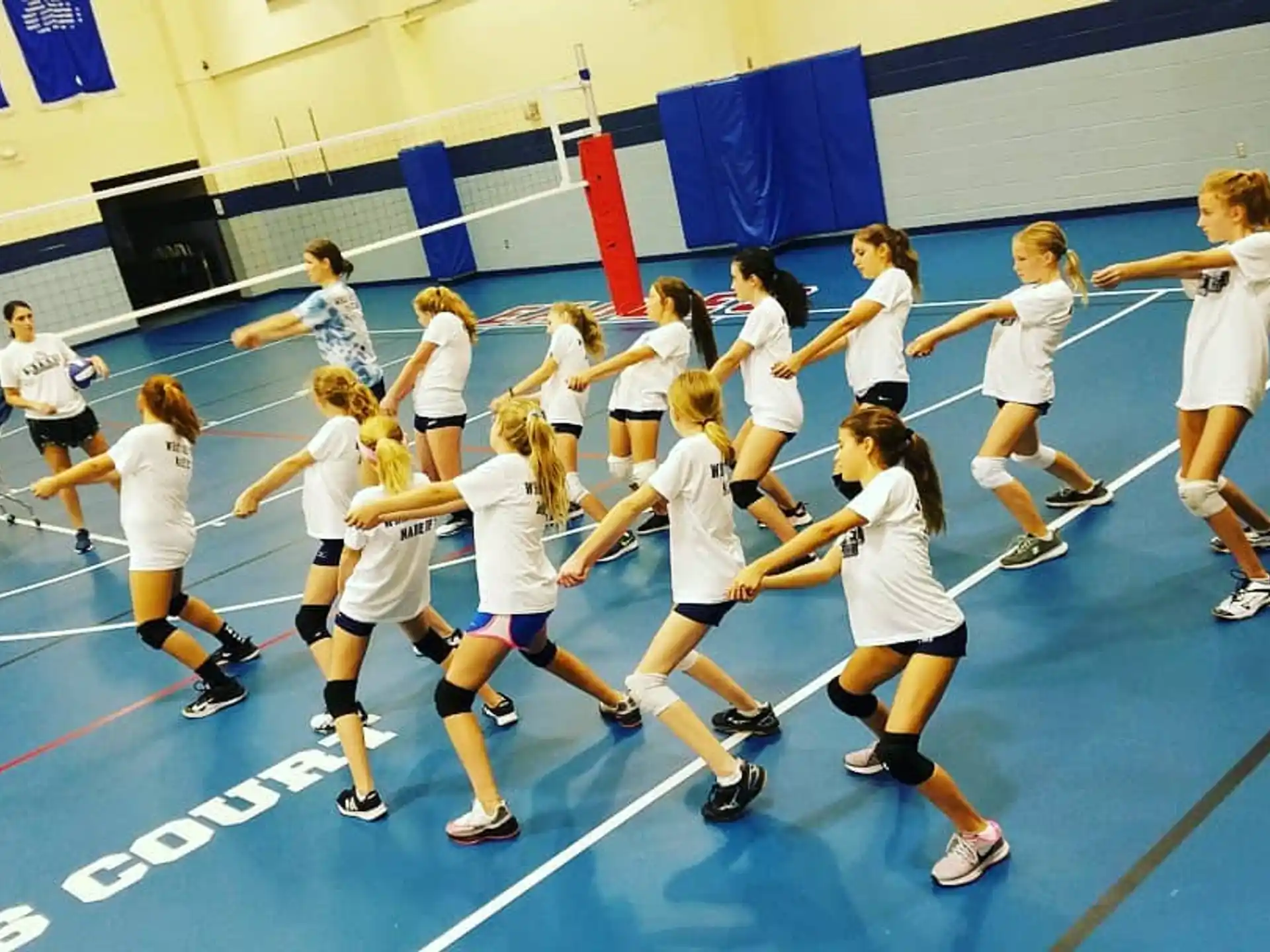 a group of girls playing volleyball
