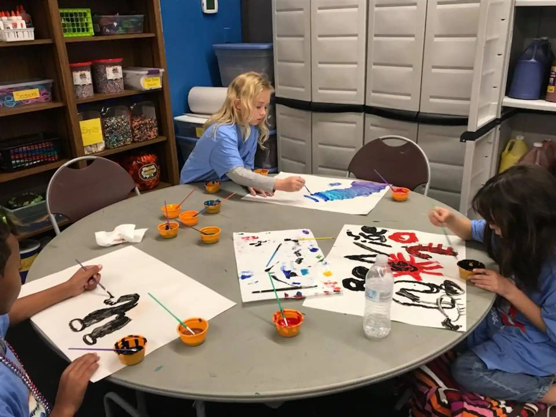 a group of people sitting around a table with a drawing on it