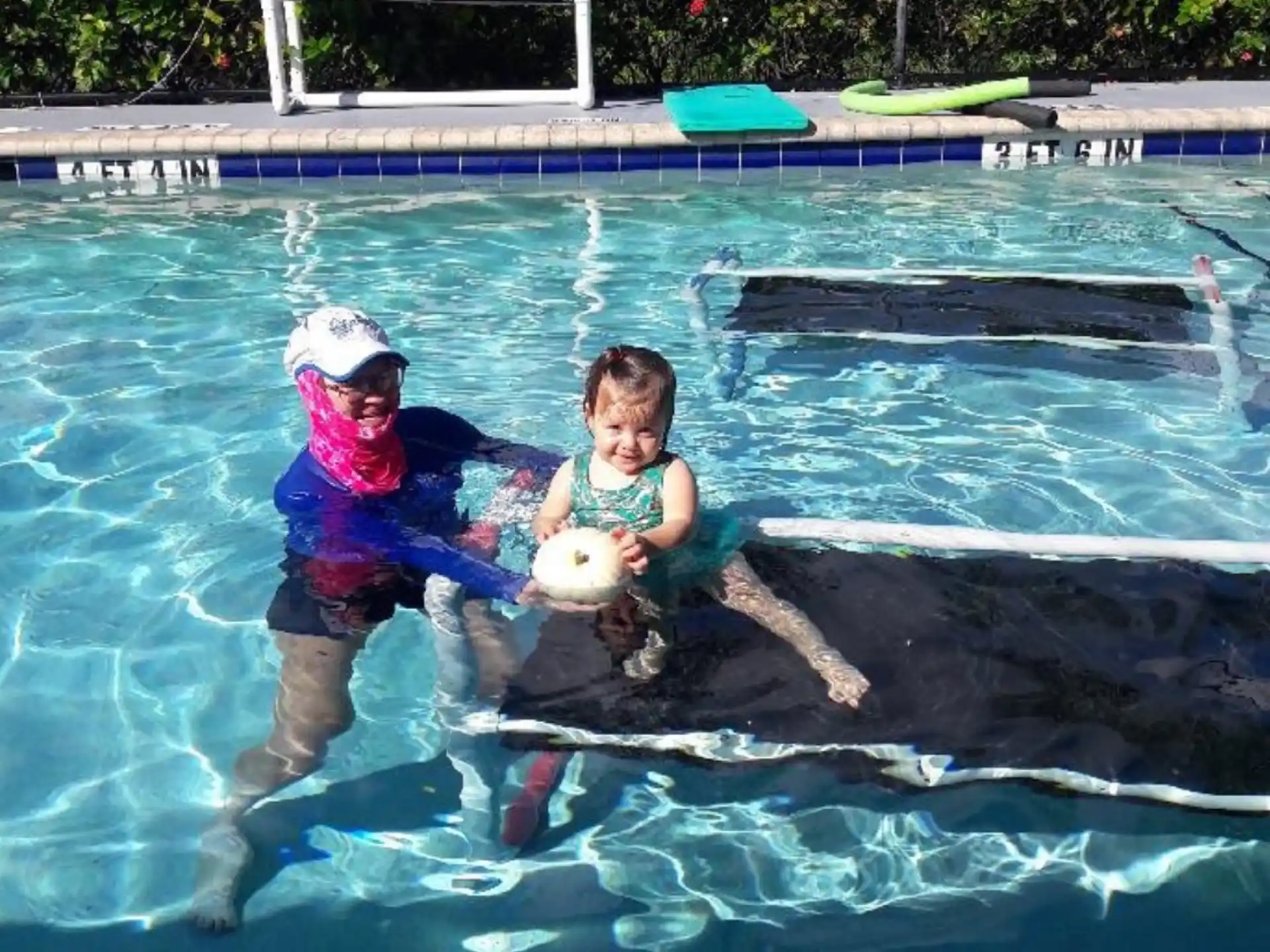 a couple of kids playing in a pool