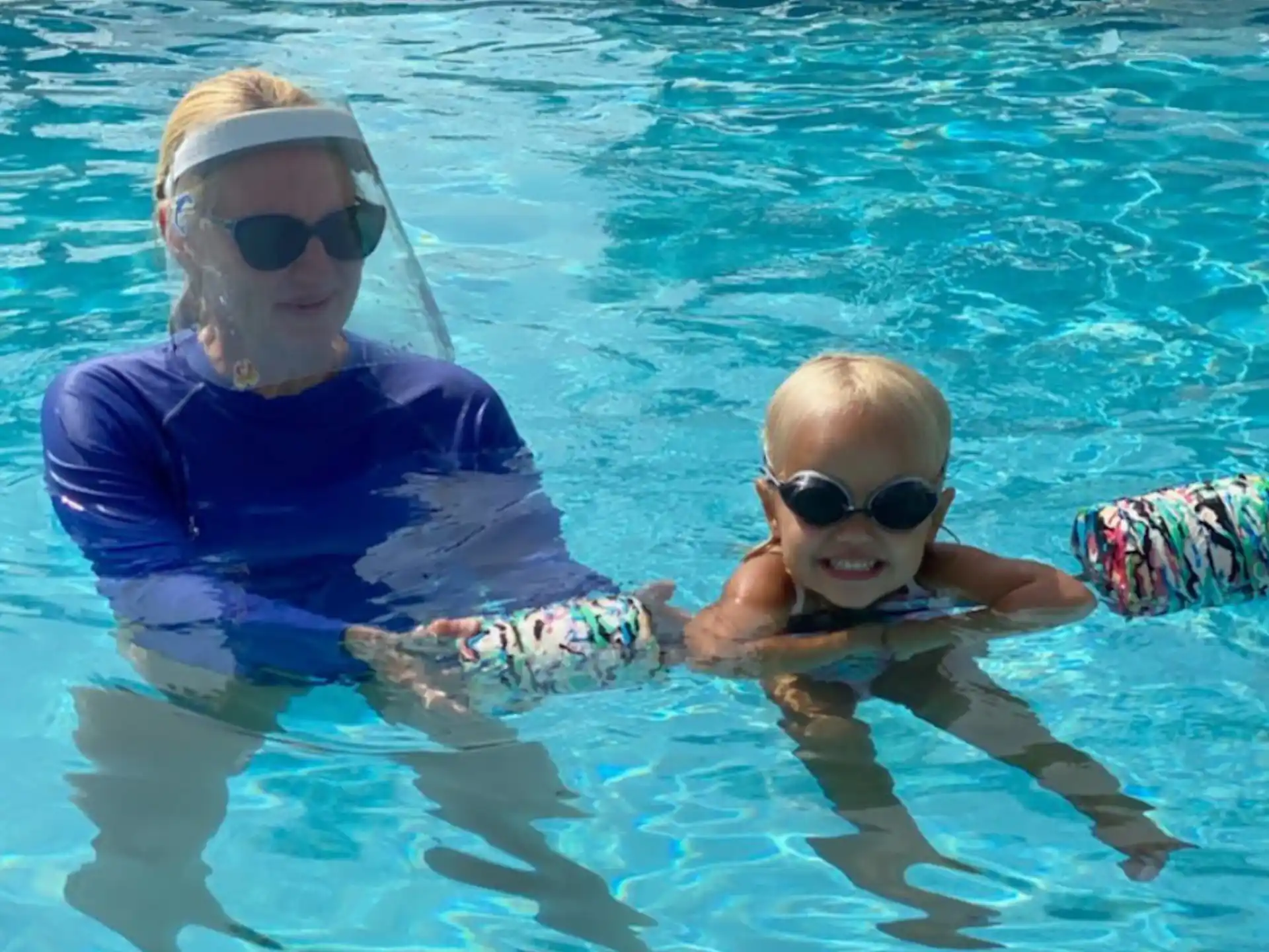 a person and a baby in a pool