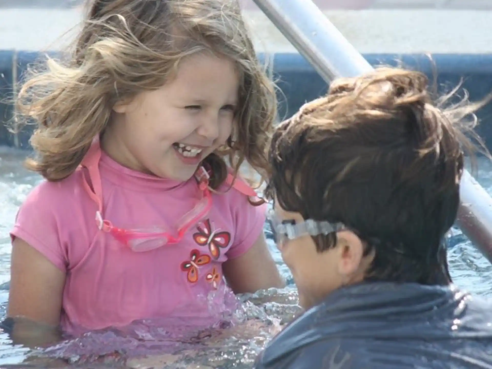a person and a child in a pool