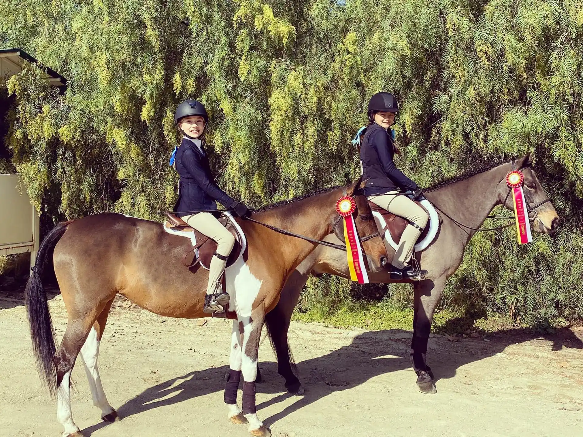 two women riding horses