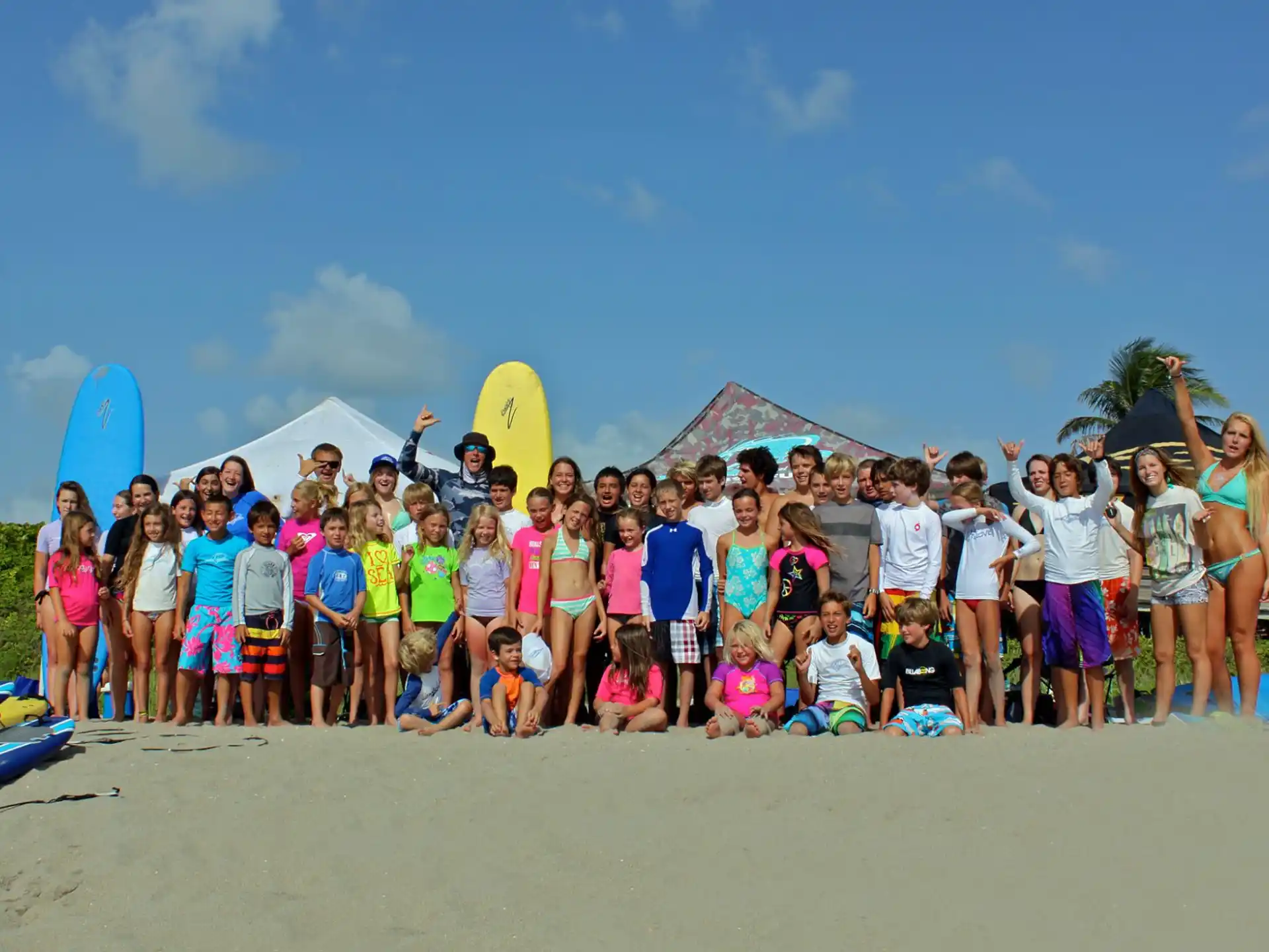 a group of people posing for a photo on a beach