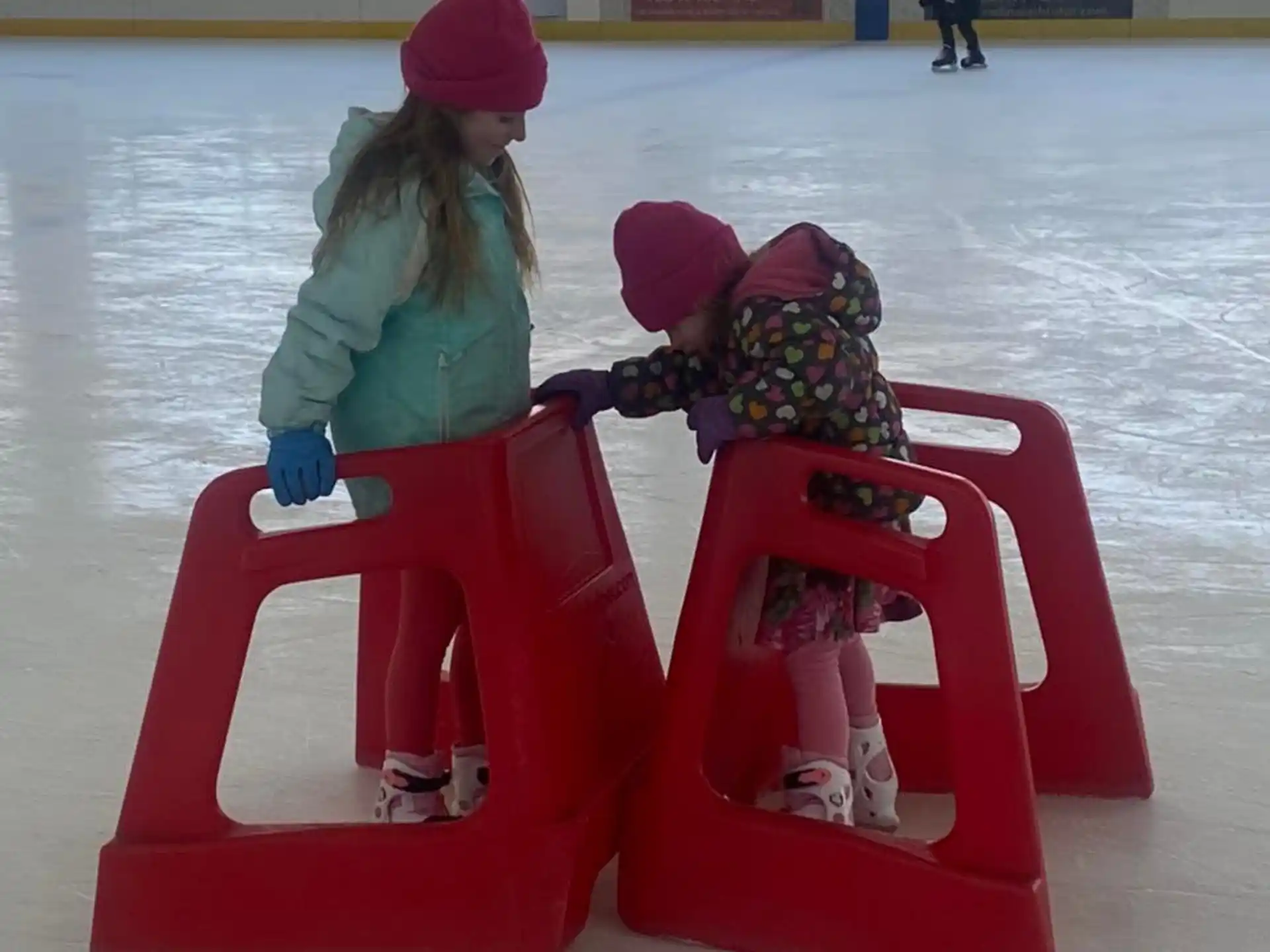 a person and a child on an ice rink