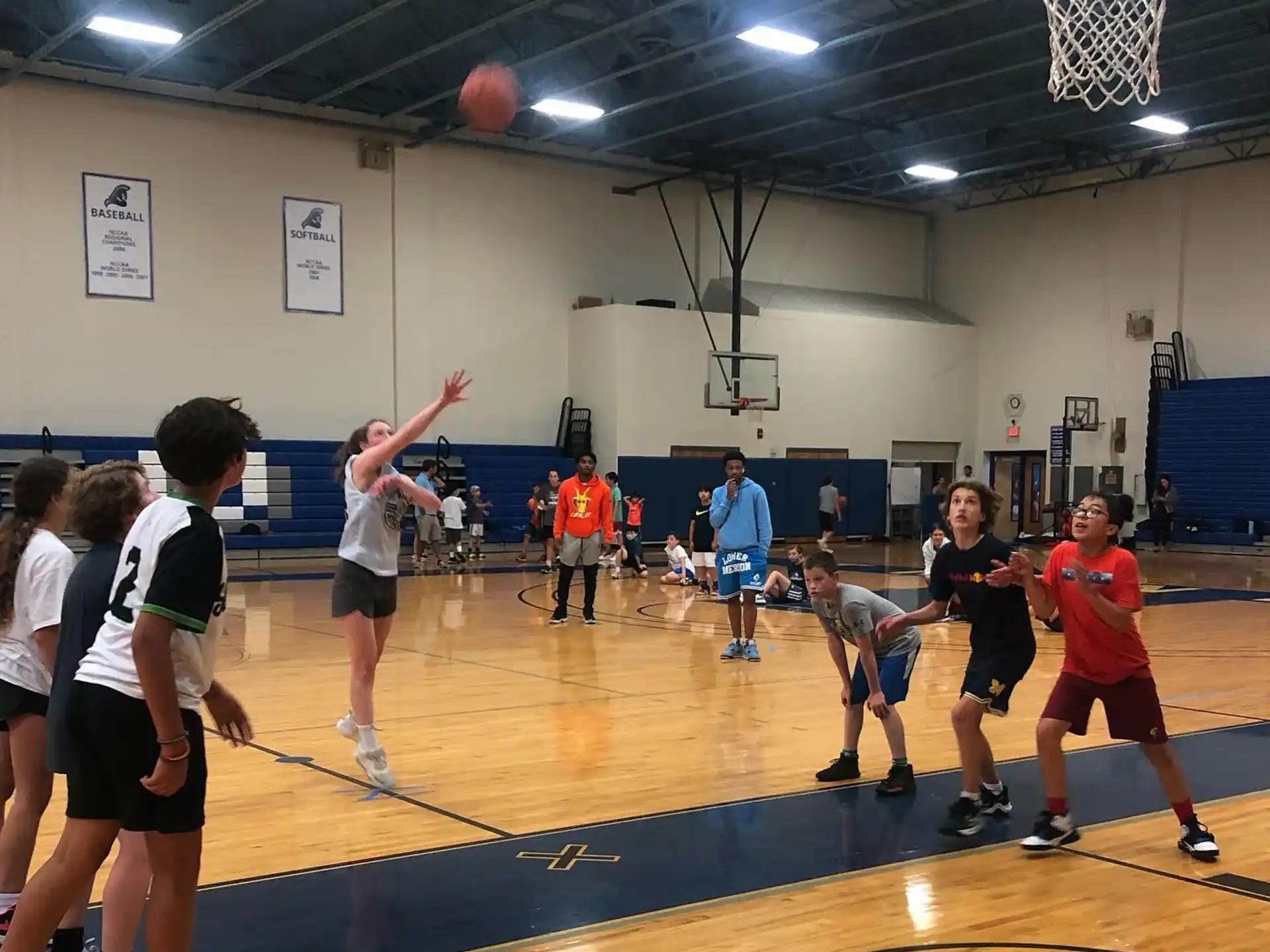 a group of people playing basketball