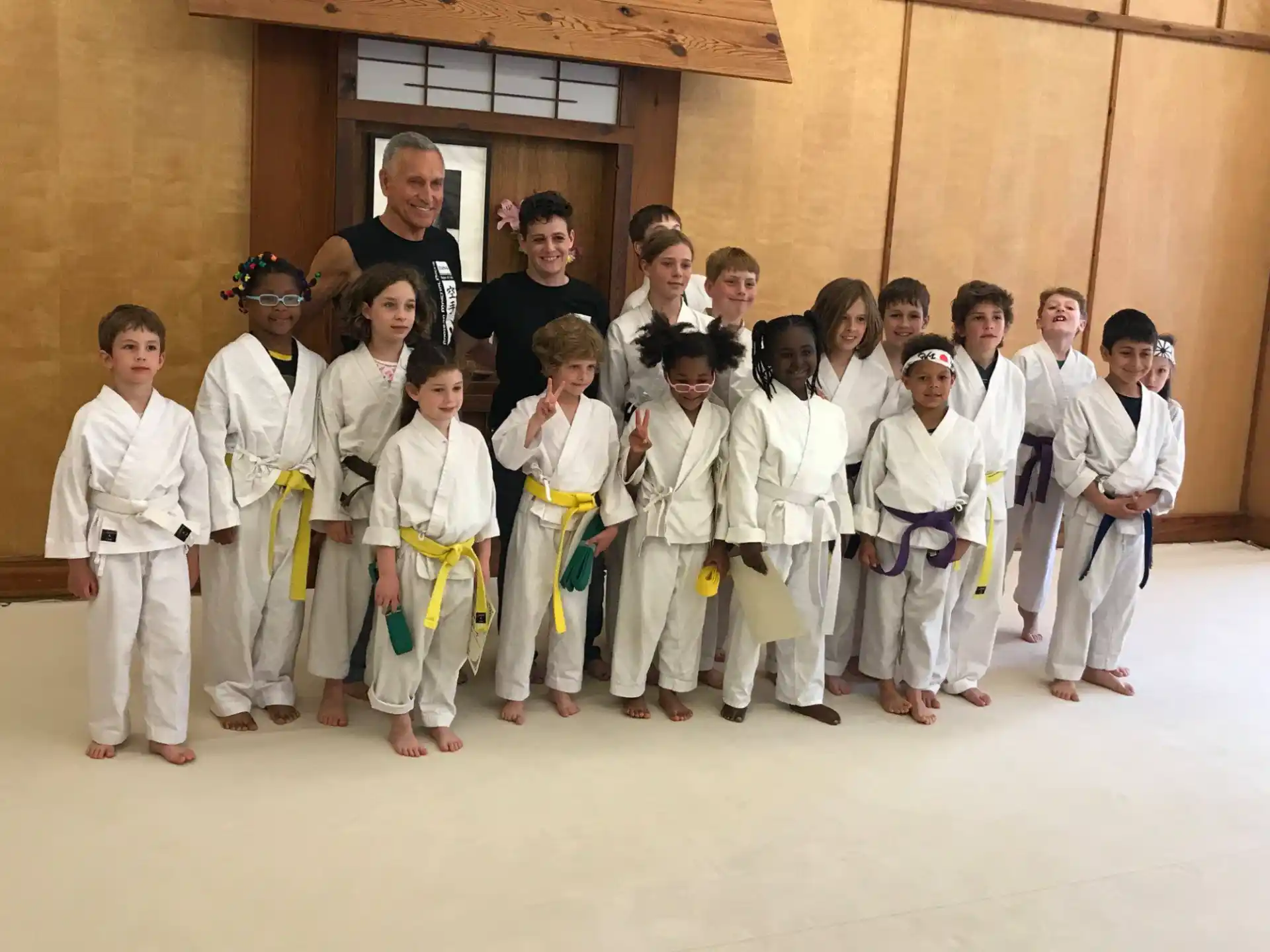 a group of children in karate uniforms