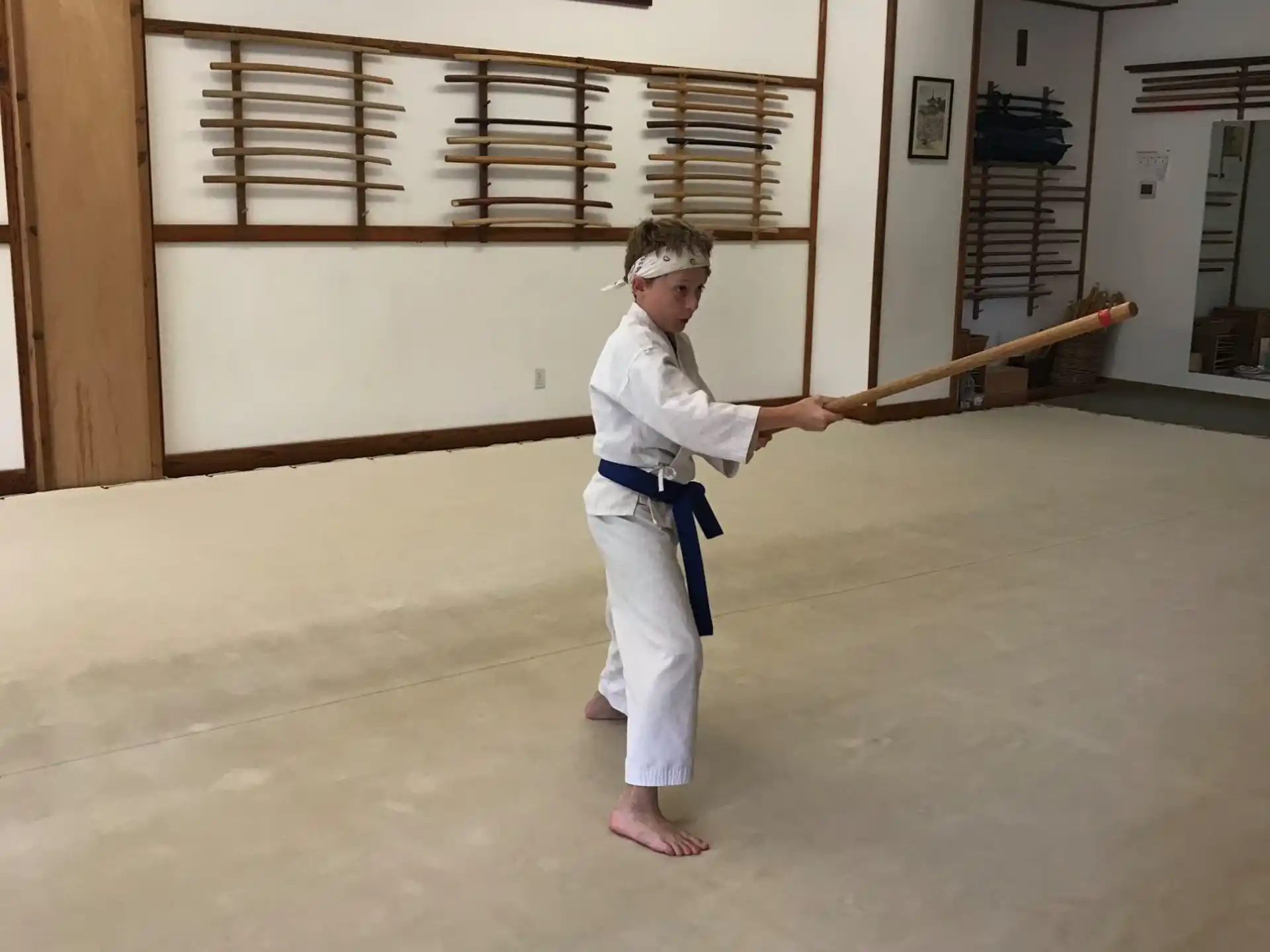 a person in a karate uniform holding a sword