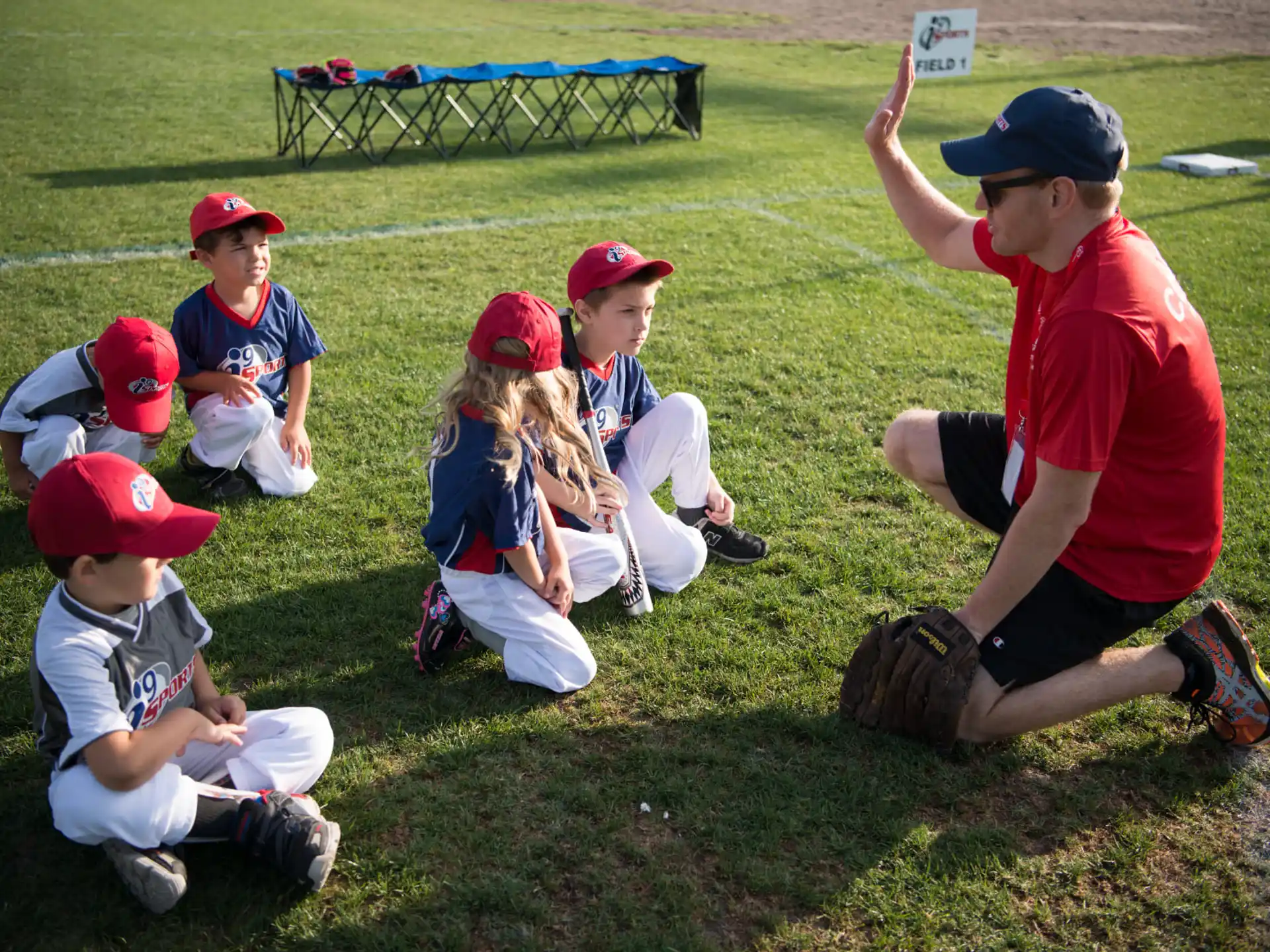 a group of kids sitting on the grass