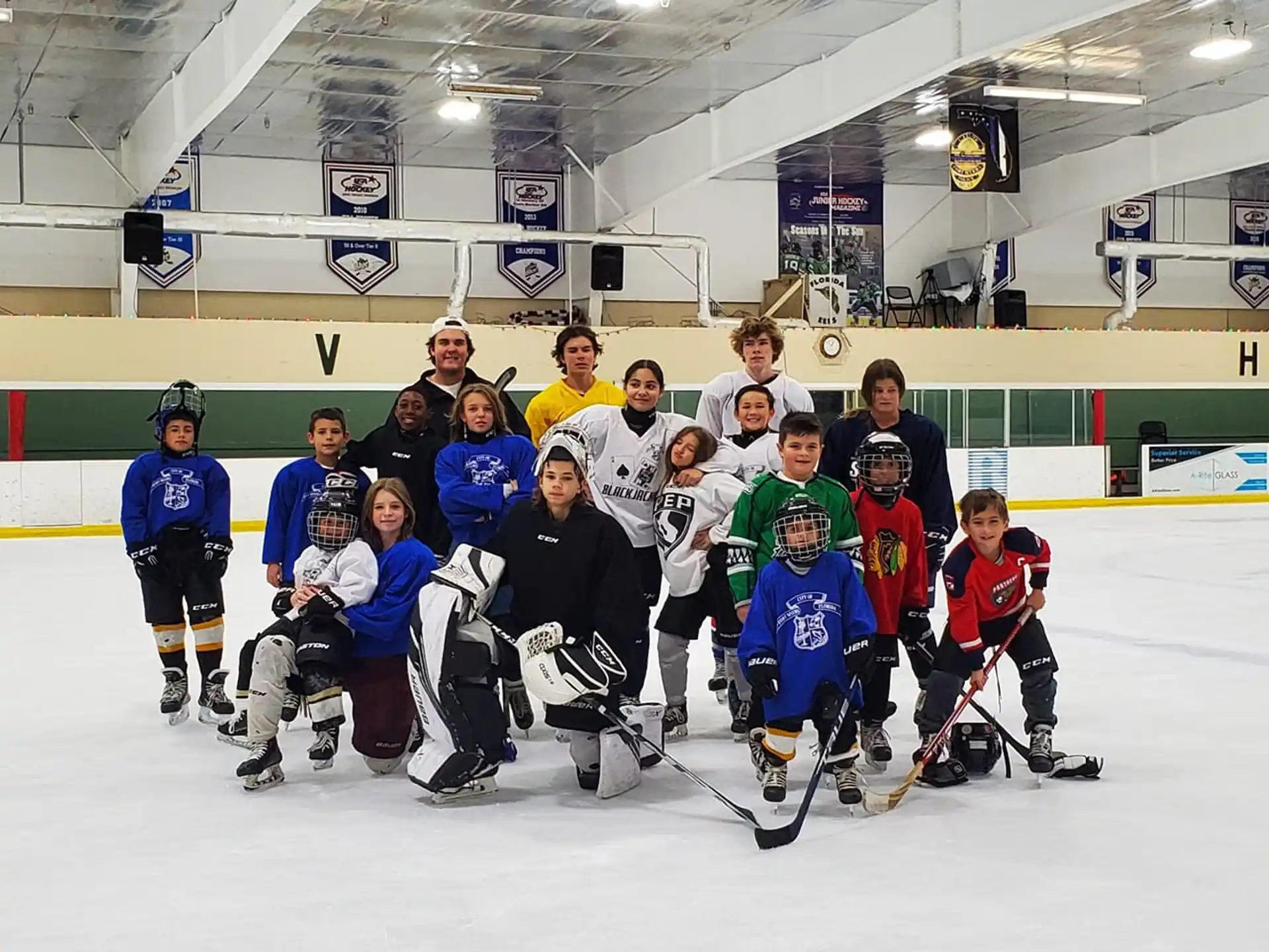 a group of people posing for a photo on an ice rink