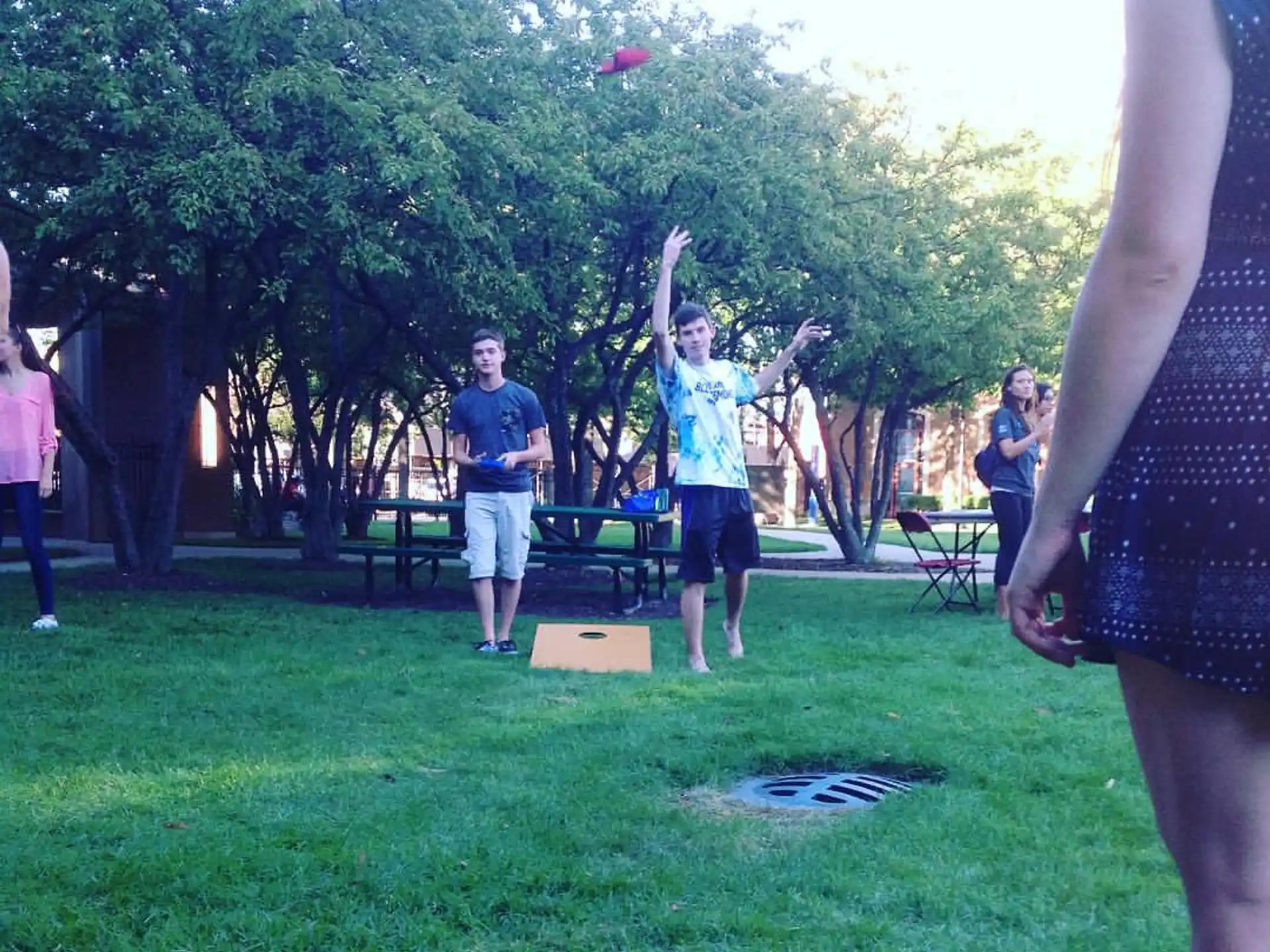 a group of people playing frisbee in a park