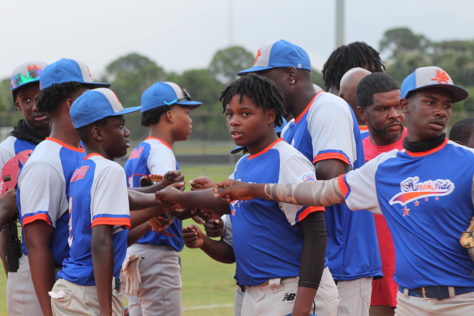 a group of people in blue shirts