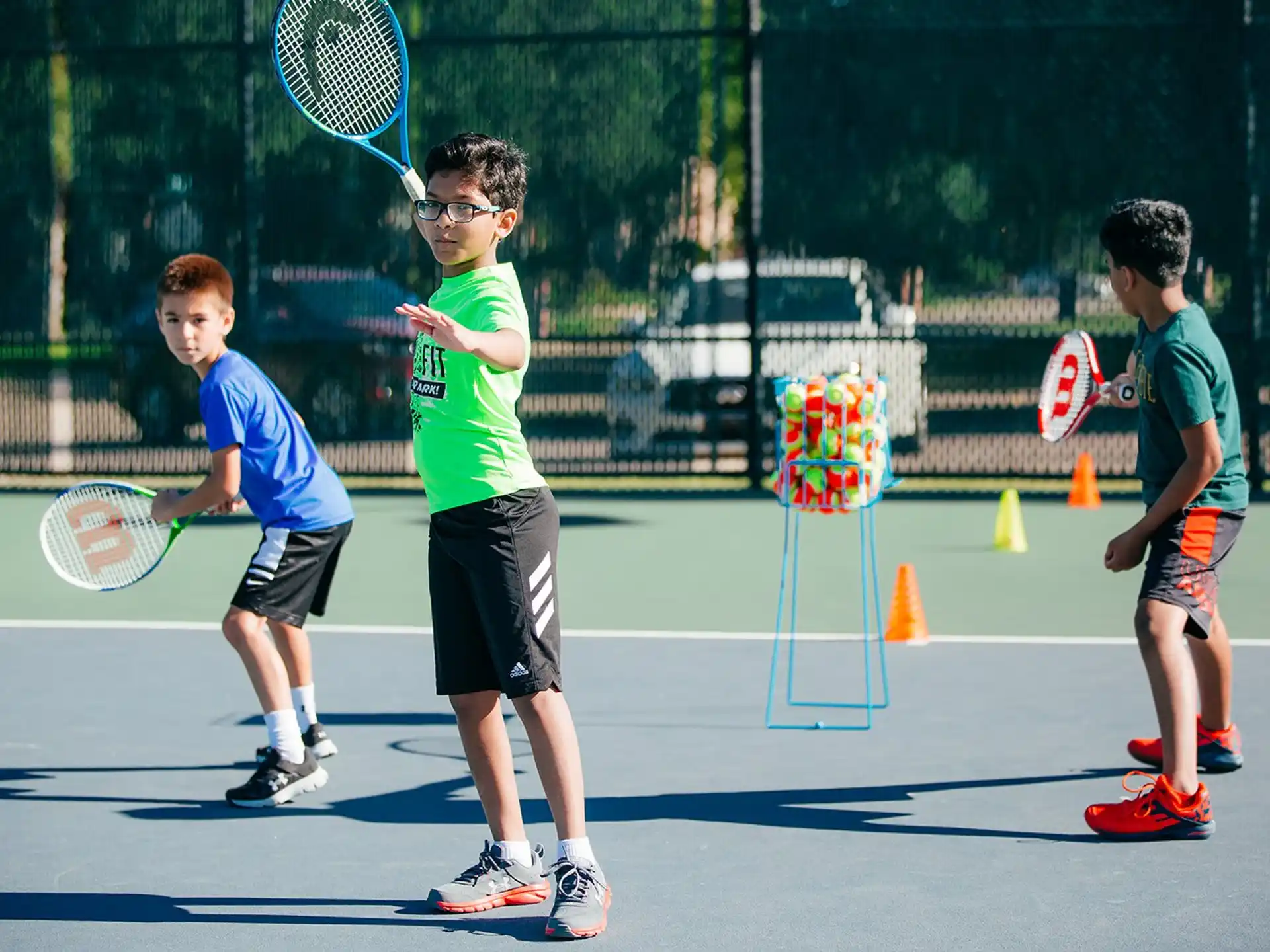 kids playing tennis on a court