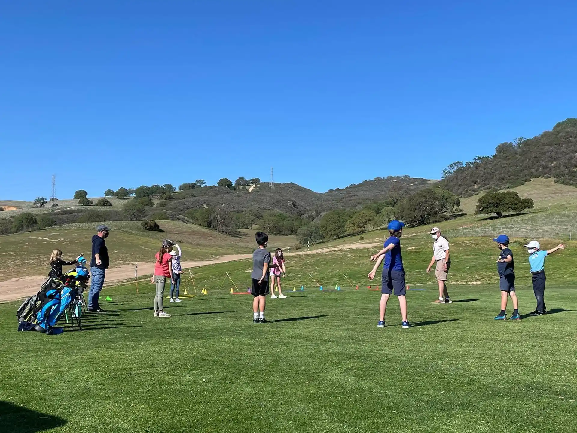 a group of people standing on a grassy field