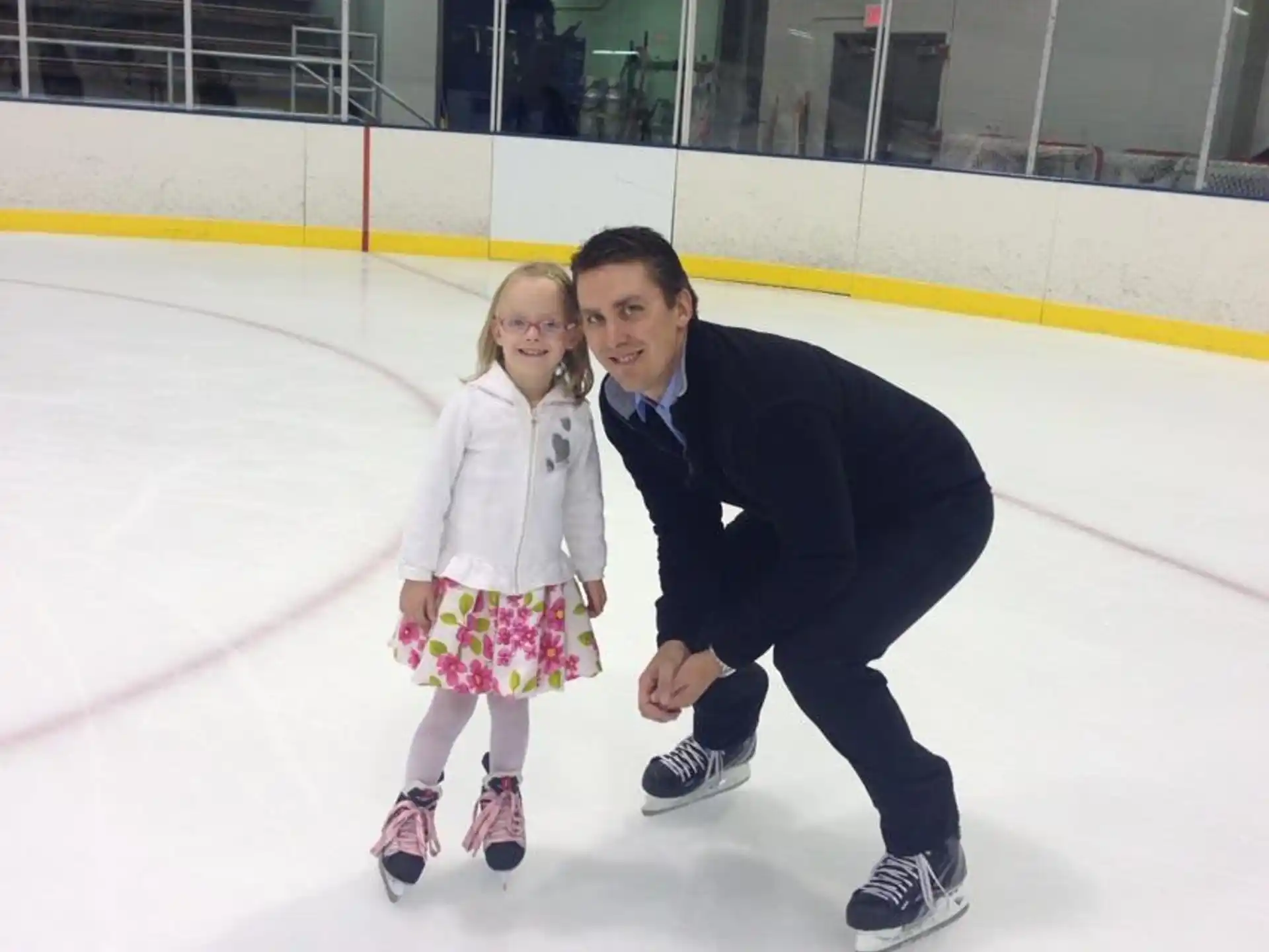 a person and a girl on an ice rink