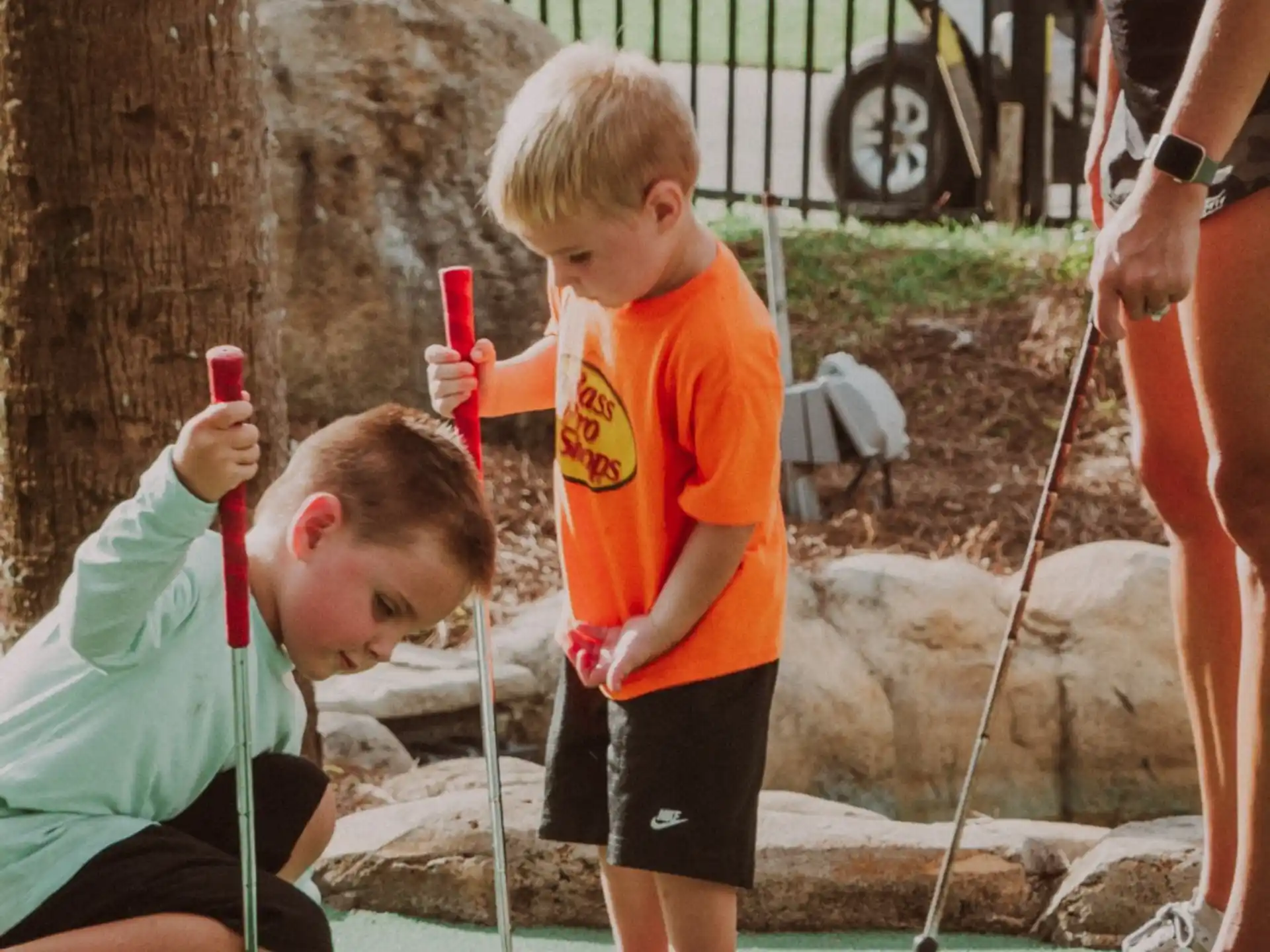 a person and a boy playing with sticks
