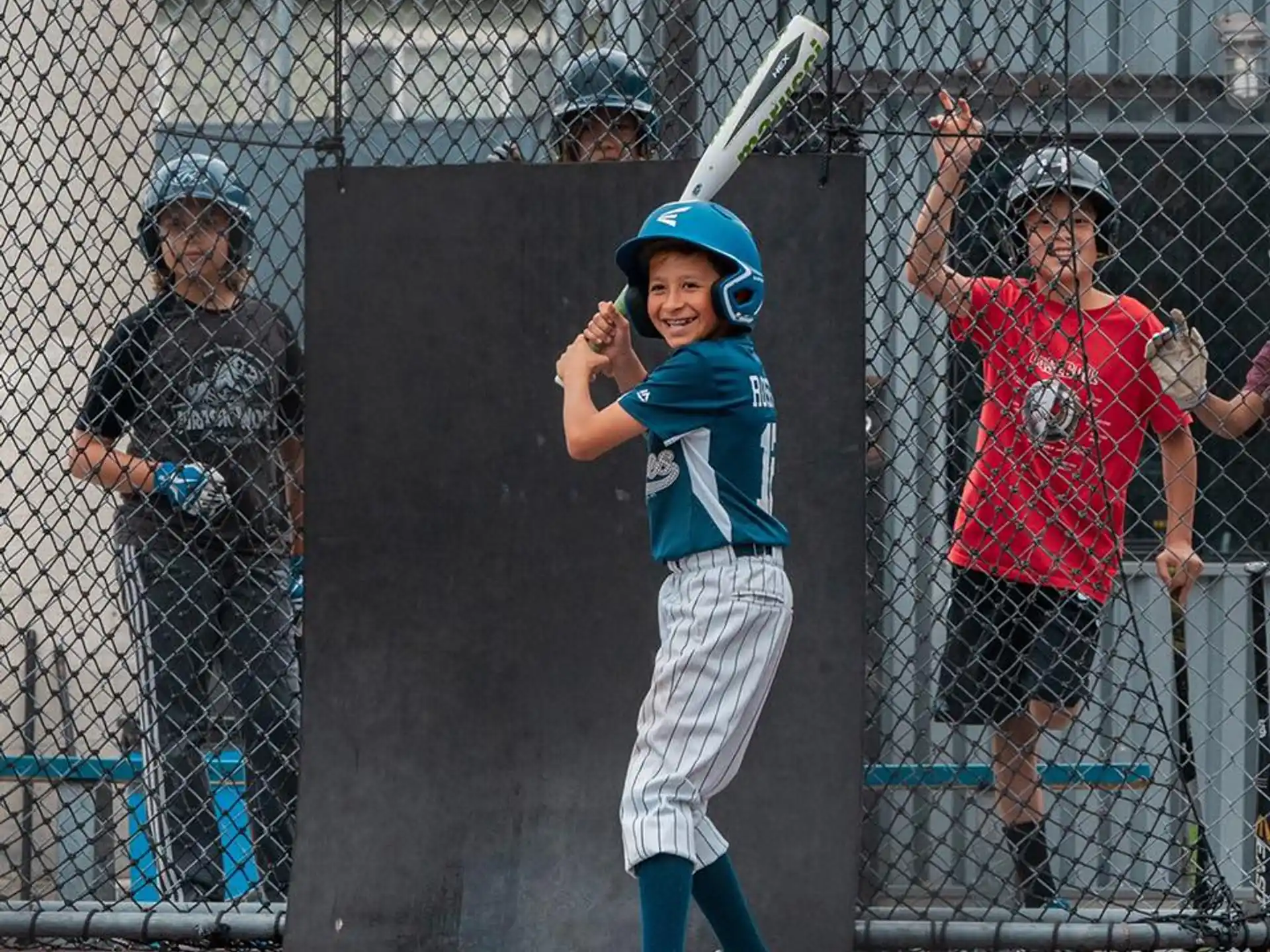 a kid holding a baseball bat