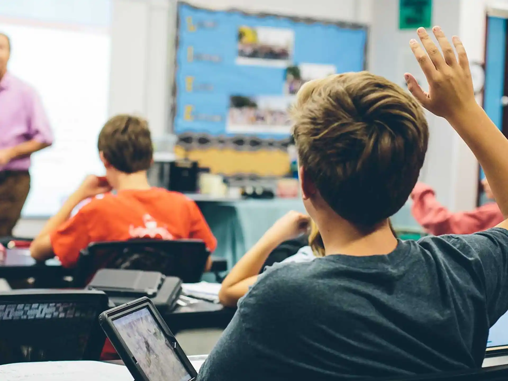 a boy raising his hand