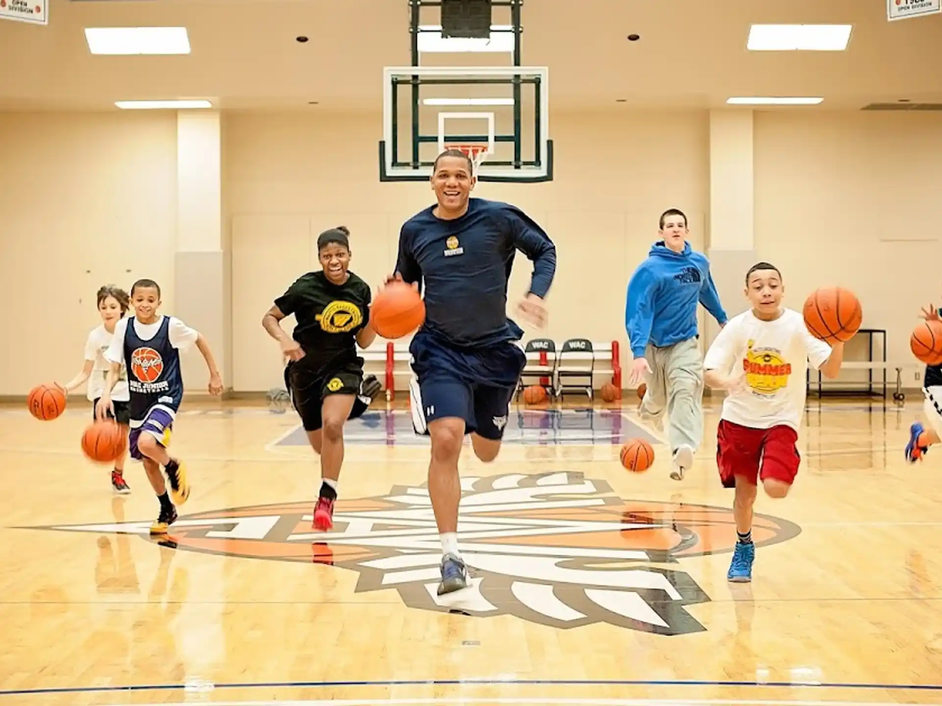 a group of kids playing basketball