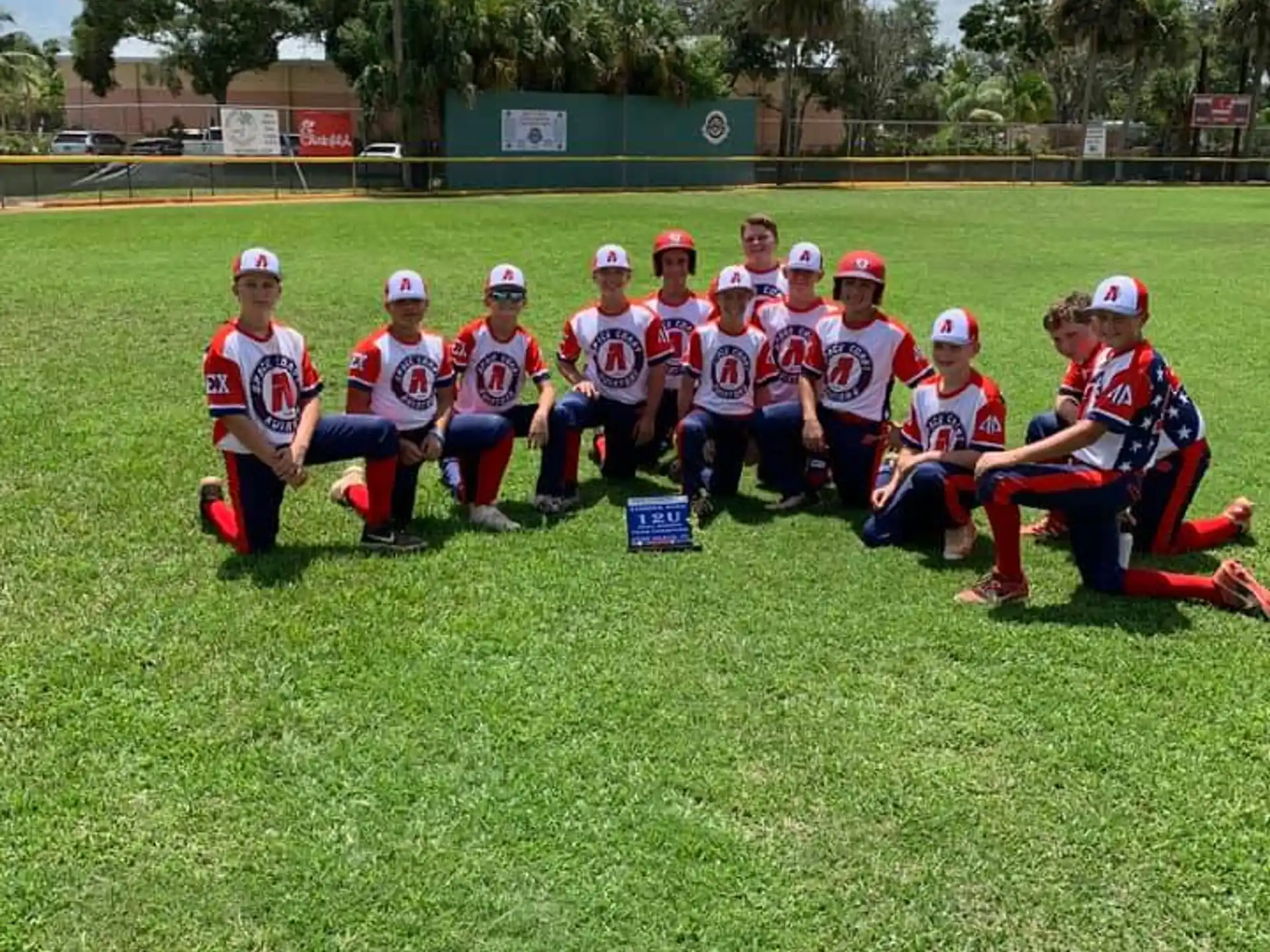 a group of people in sports uniforms posing for a photo